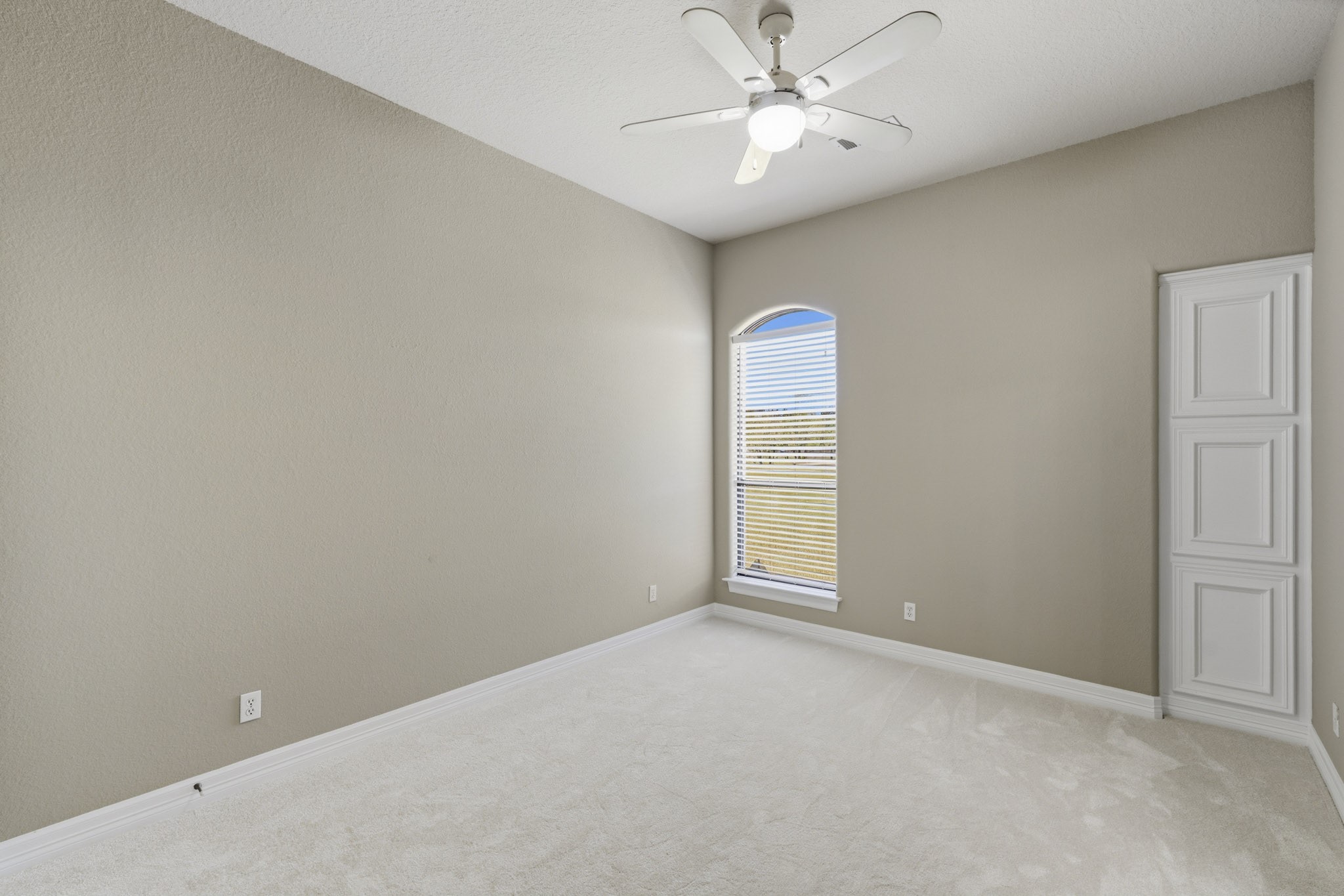 Additional bedroom with high ceiling and large window