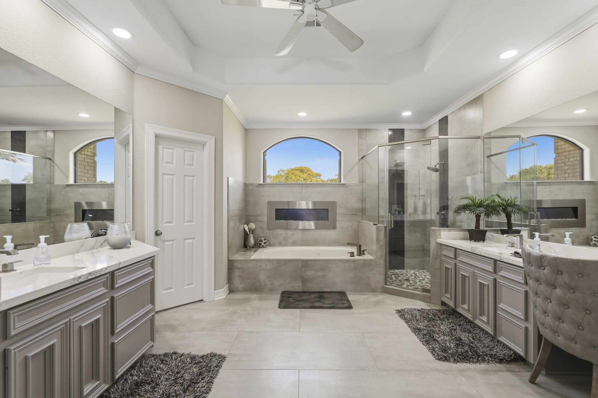 Luxurious primary bathroom with dual vanities and soaking tub