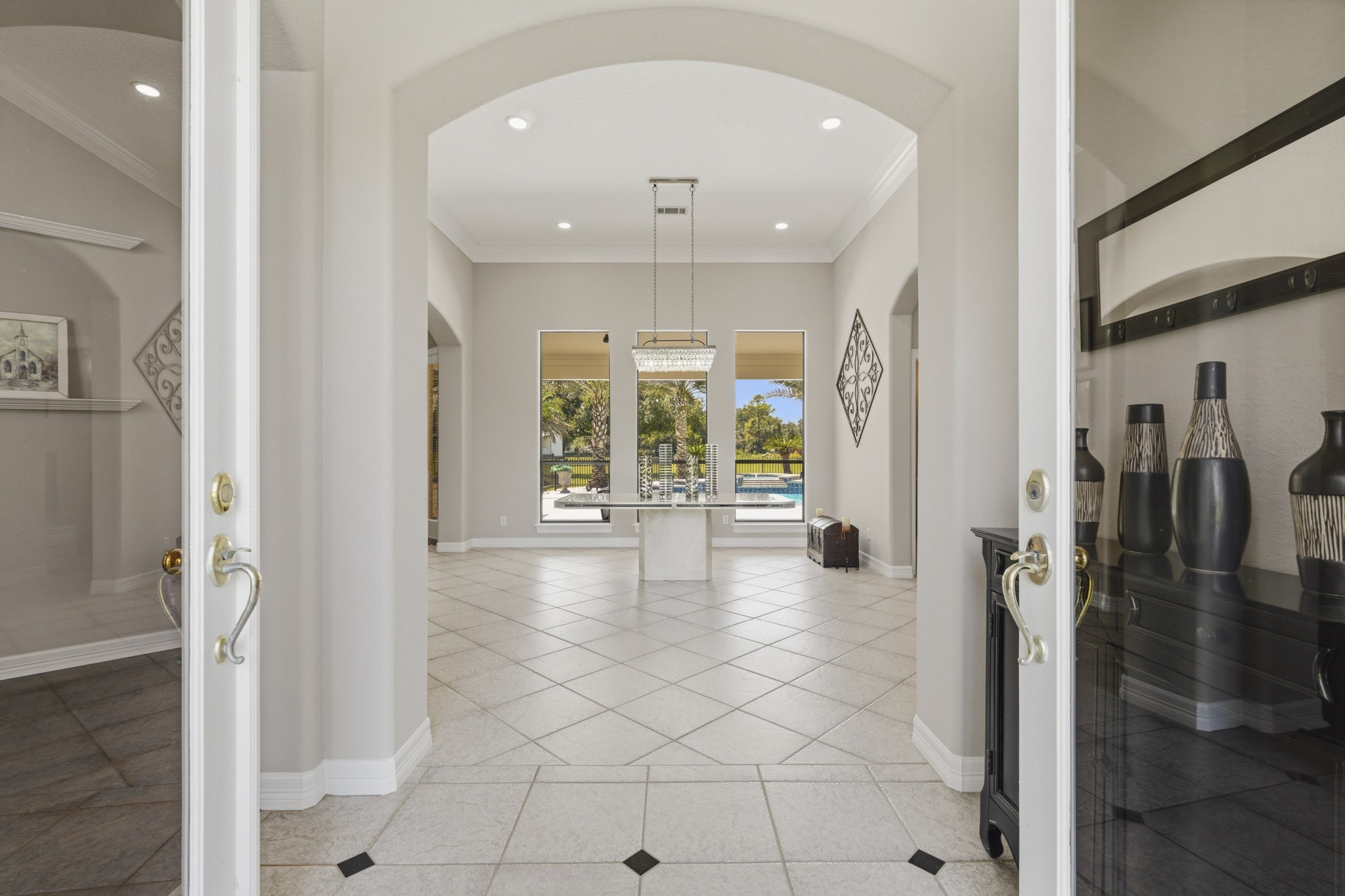 Grand entry with arched openings and abundant natural light