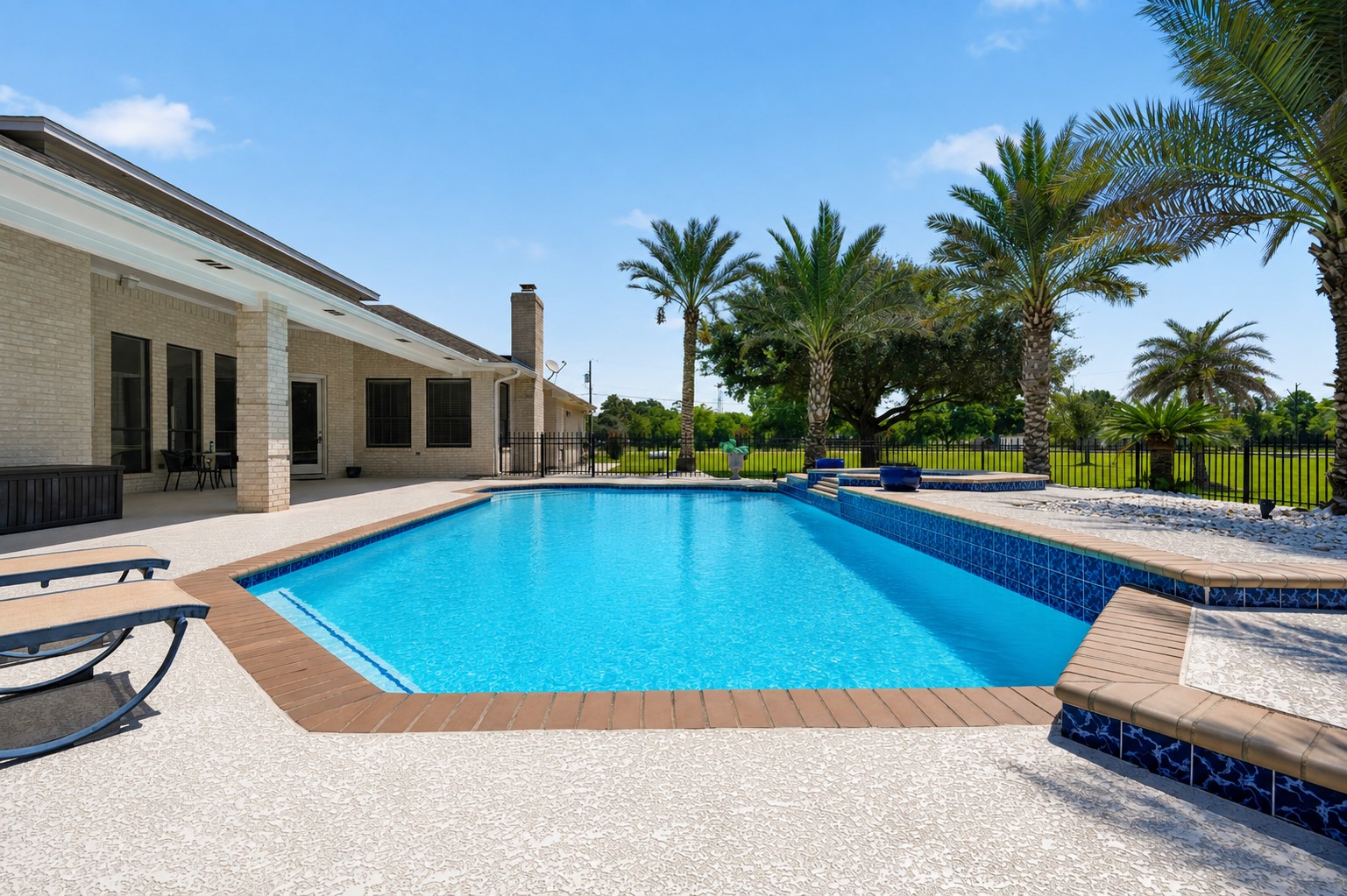 Sparkling pool and spa with generous surrounding patio space