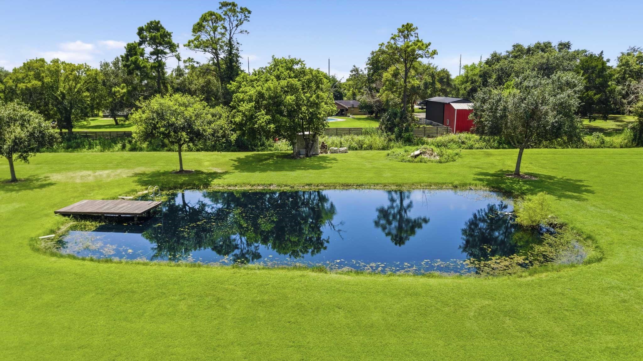 Picturesque pond surrounded by mature trees and open lawn. Stocked with Blue gill and bass