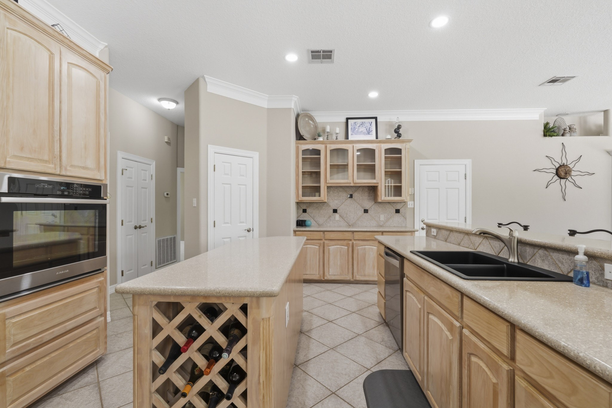 Generous kitchen workspace with extensive cabinetry