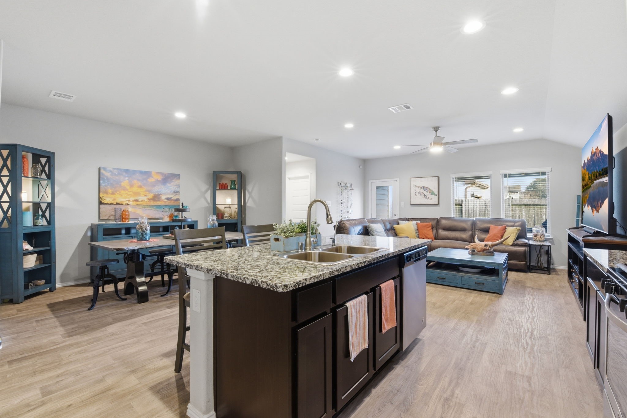 Modern kitchen with island, breakfast bar, and open layout to living room. Modern kitchen with island, breakfast bar, and open layout to living room.