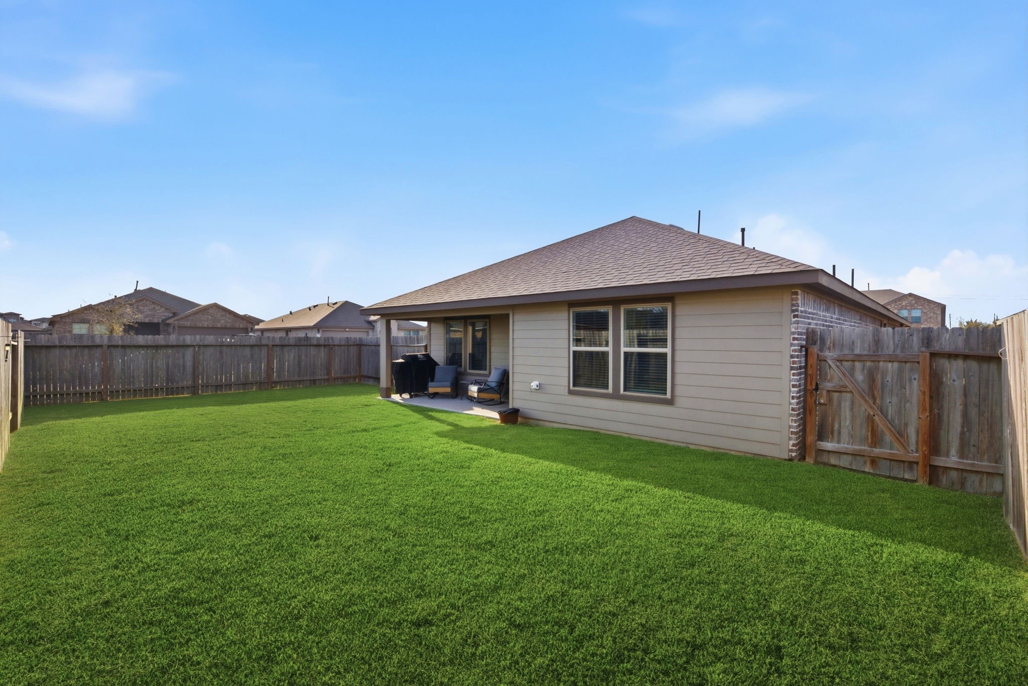 Private fenced backyard with covered patioperfect for entertaining.