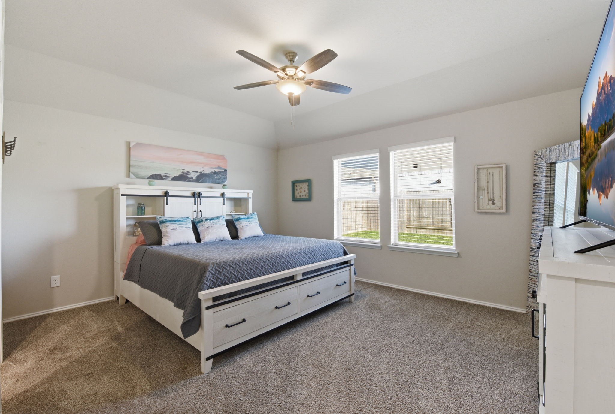 Spacious primary bedroom retreat with natural light and ceiling fan. Spacious primary bedroom retreat with natural light and ceiling fan.
