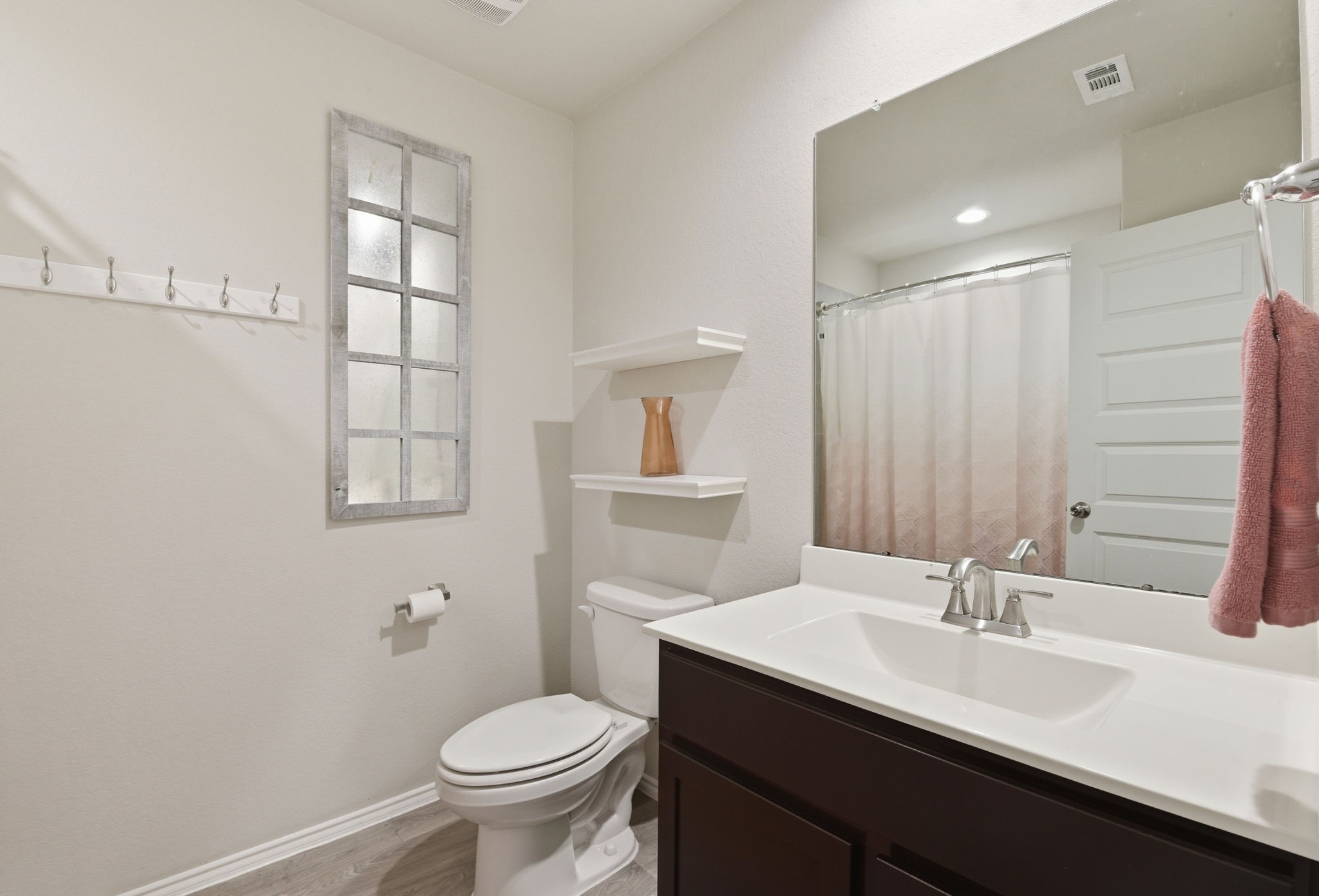 Clean and bright secondary bathroom with modern fixtures.