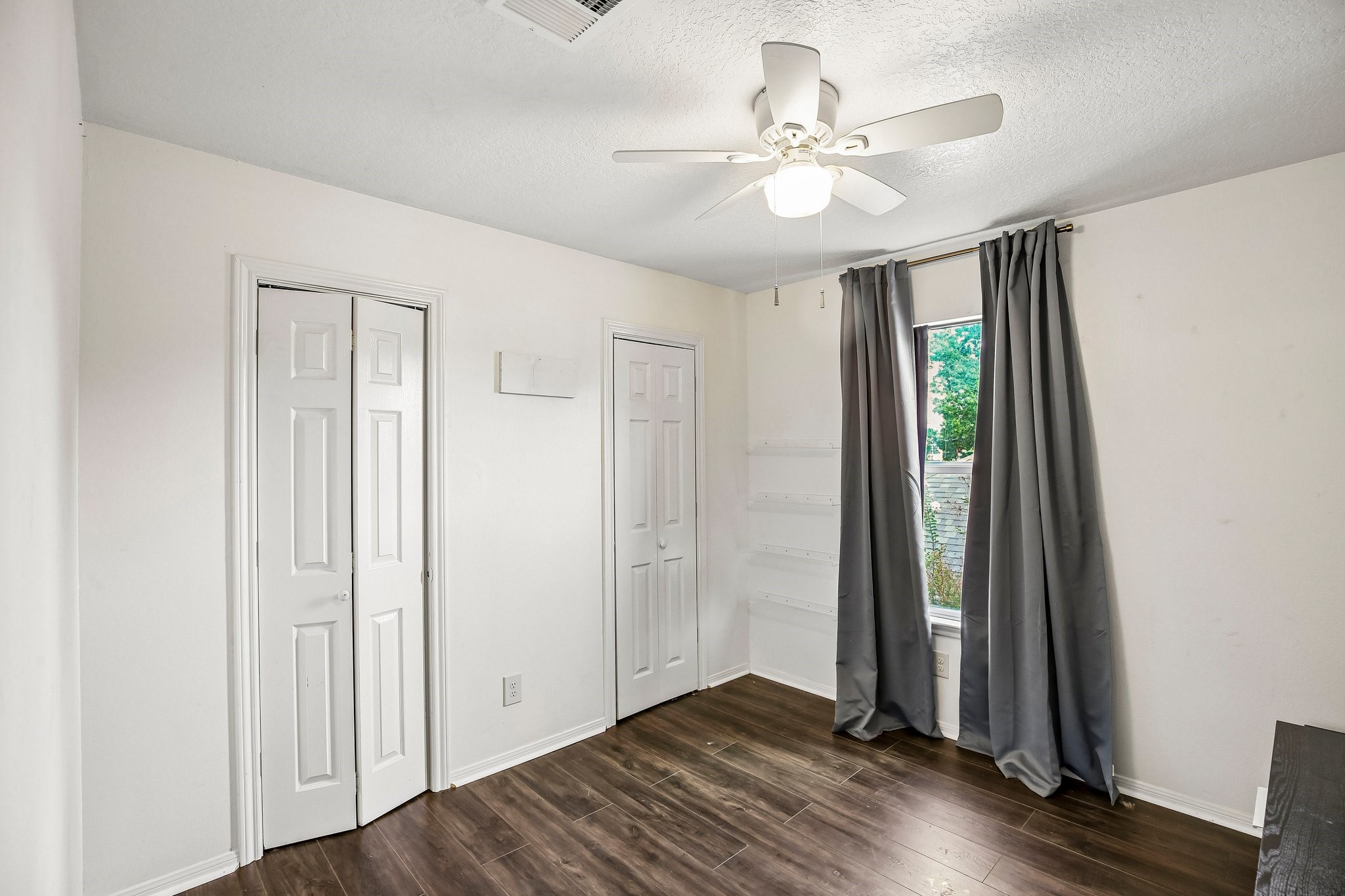 Secondary upstairs bedrooms. One of the closets has attic access.