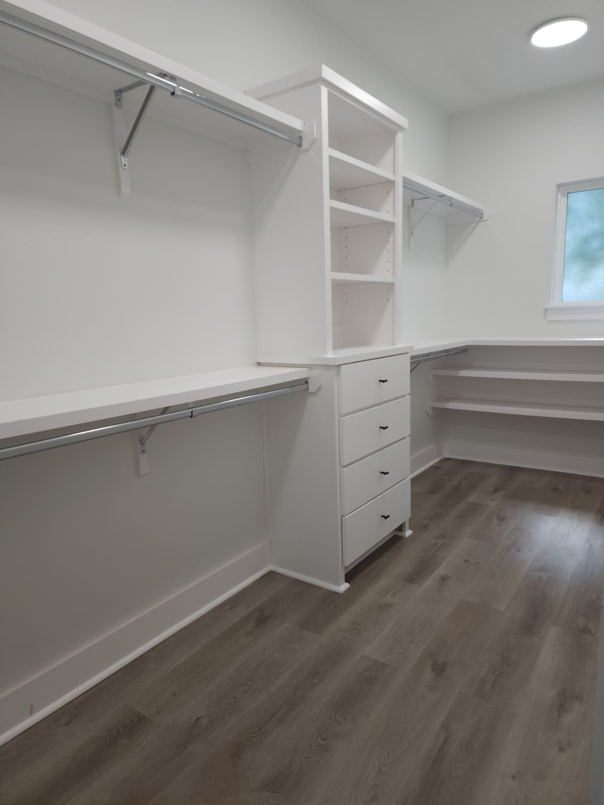 Expansive walk-in closet with ample shelving and storage, perfect for organizing a vast shoe collection.