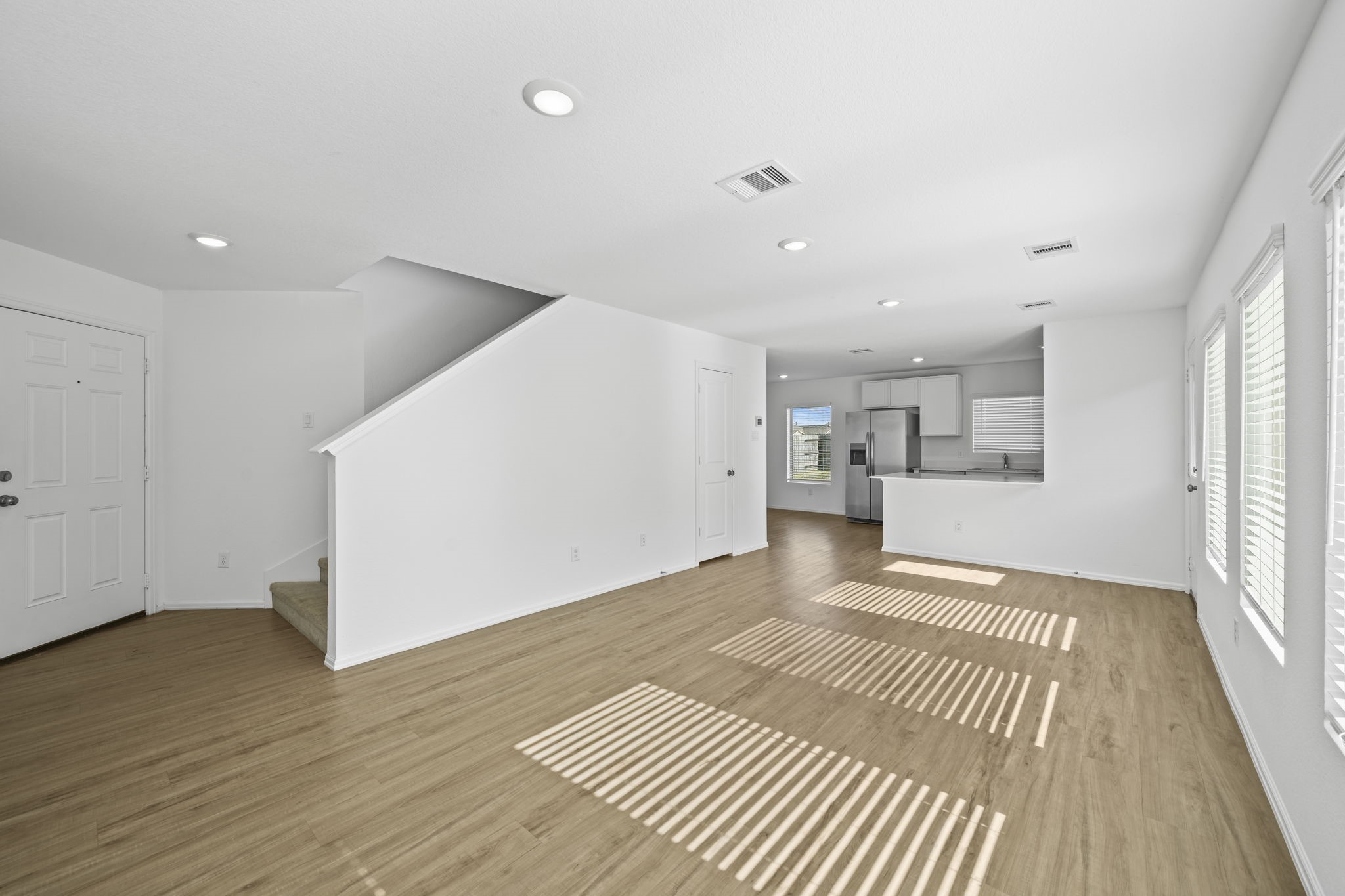 Open concept living room leading into kitchen