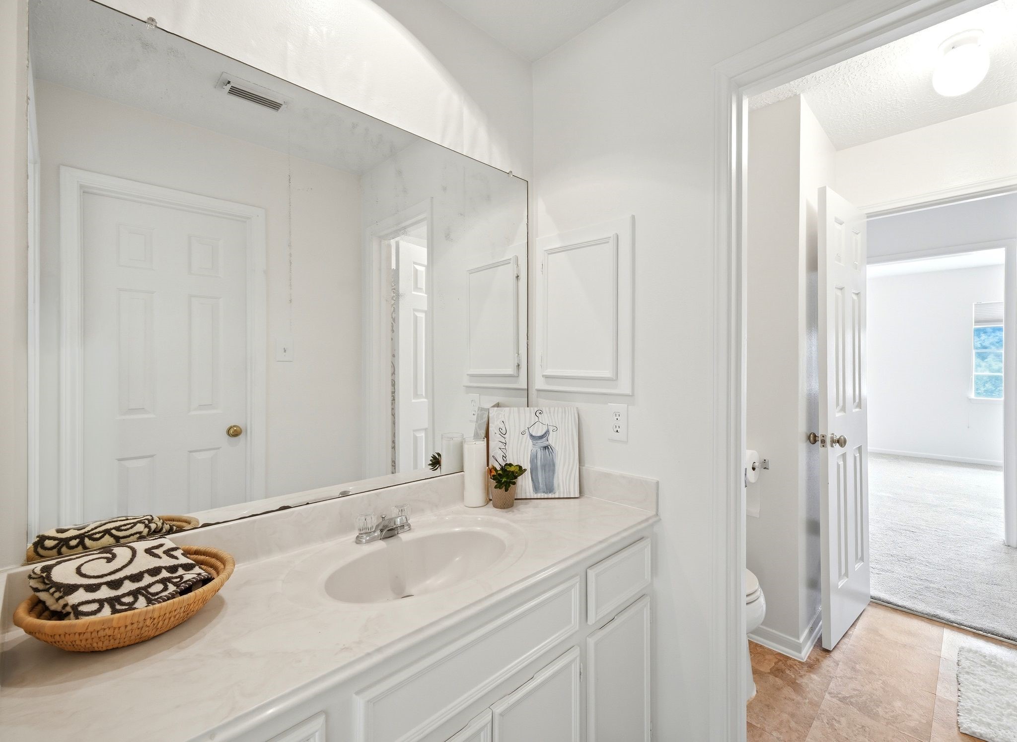 Elegant vanity area with ample counter space and a large mirror, perfectly positioned to enhance your morning routine.