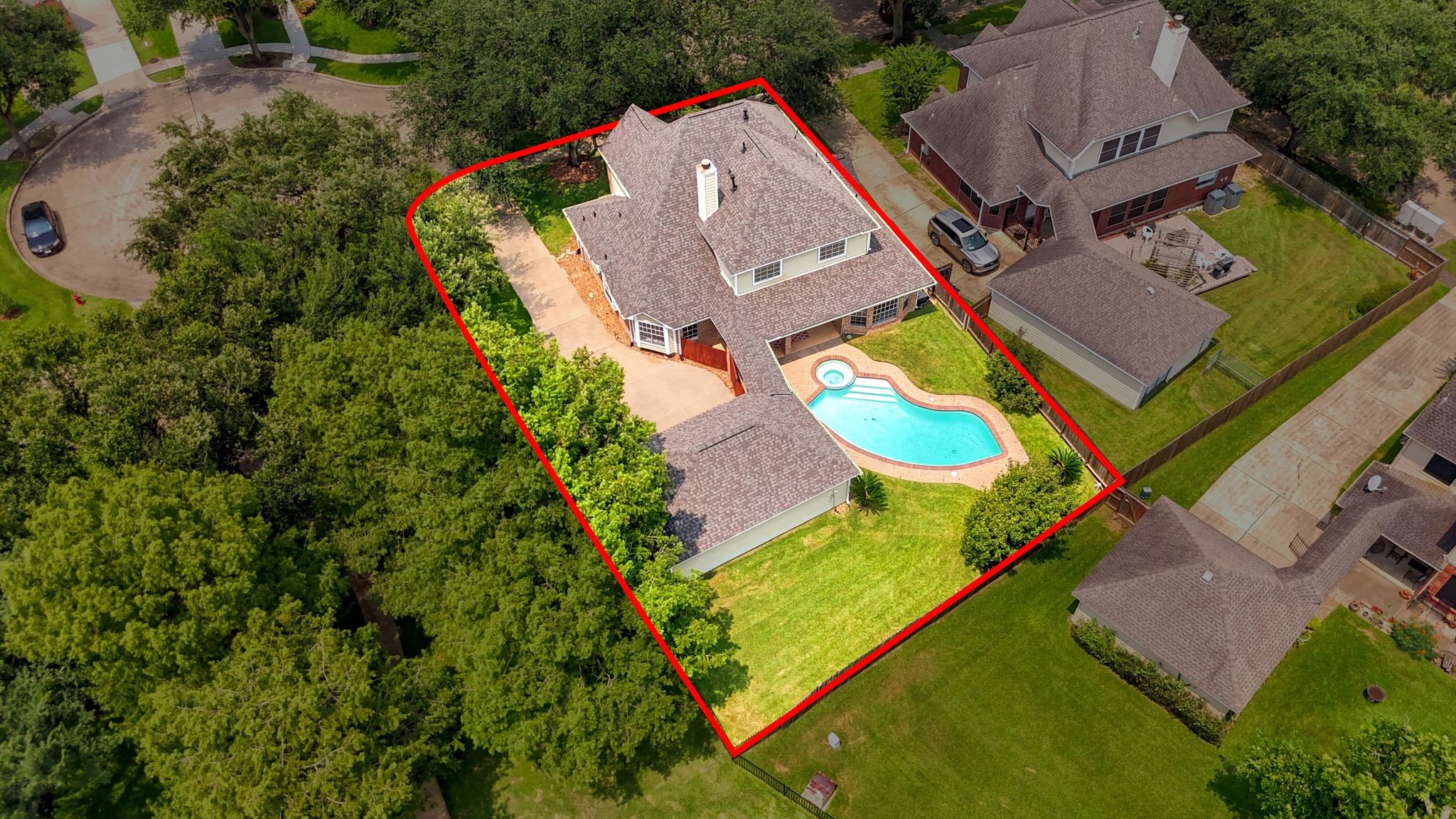 Discover a spacious two-story home nestled in a quiet neighborhood, featuring a large backyard with a sparkling swimming pool and inviting patio, surrounded by lush greenery.