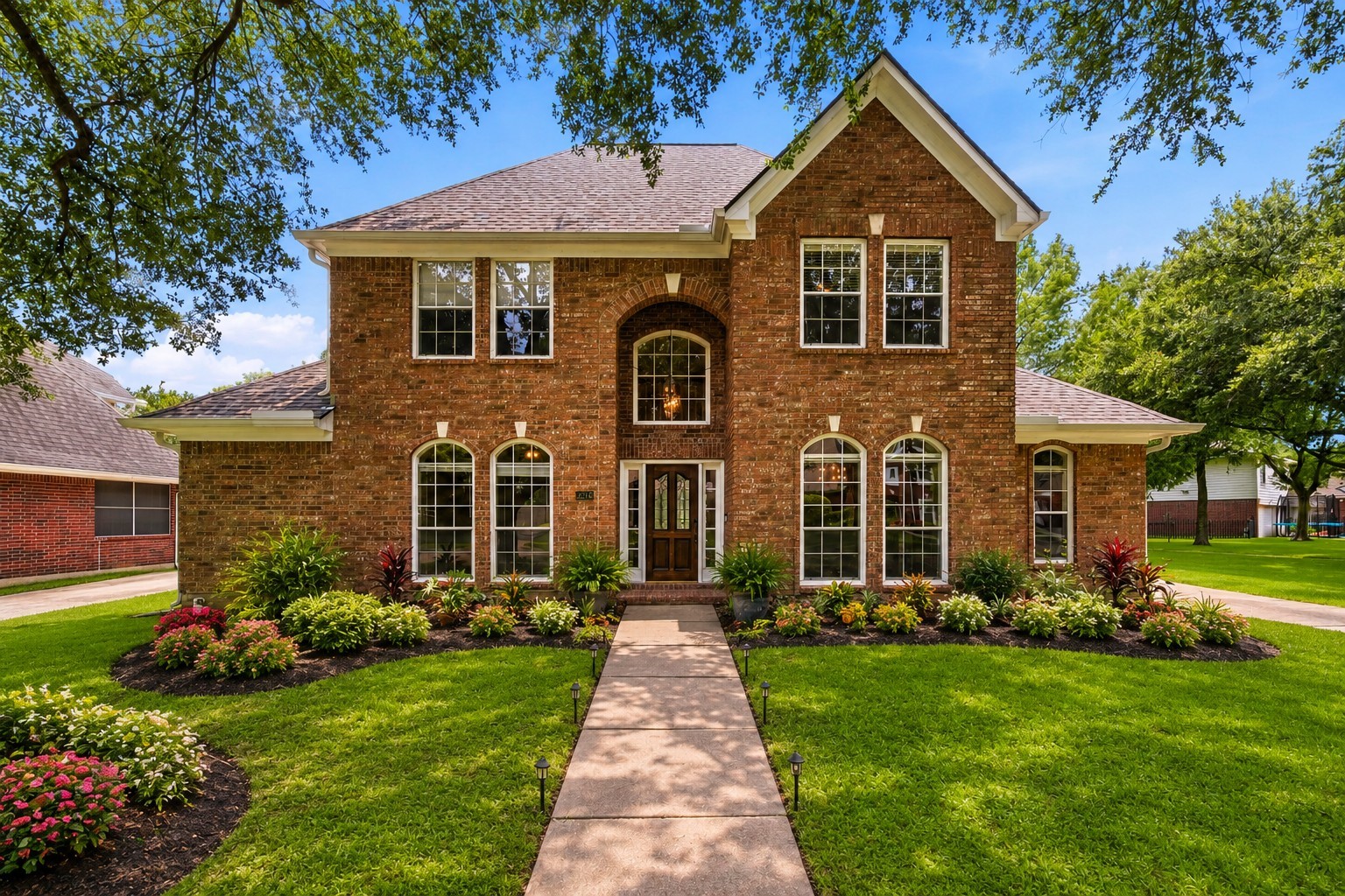 Charming brick home with an inviting facade, set amidst lush landscaping and boasting a brand-new roof for peace of mind.