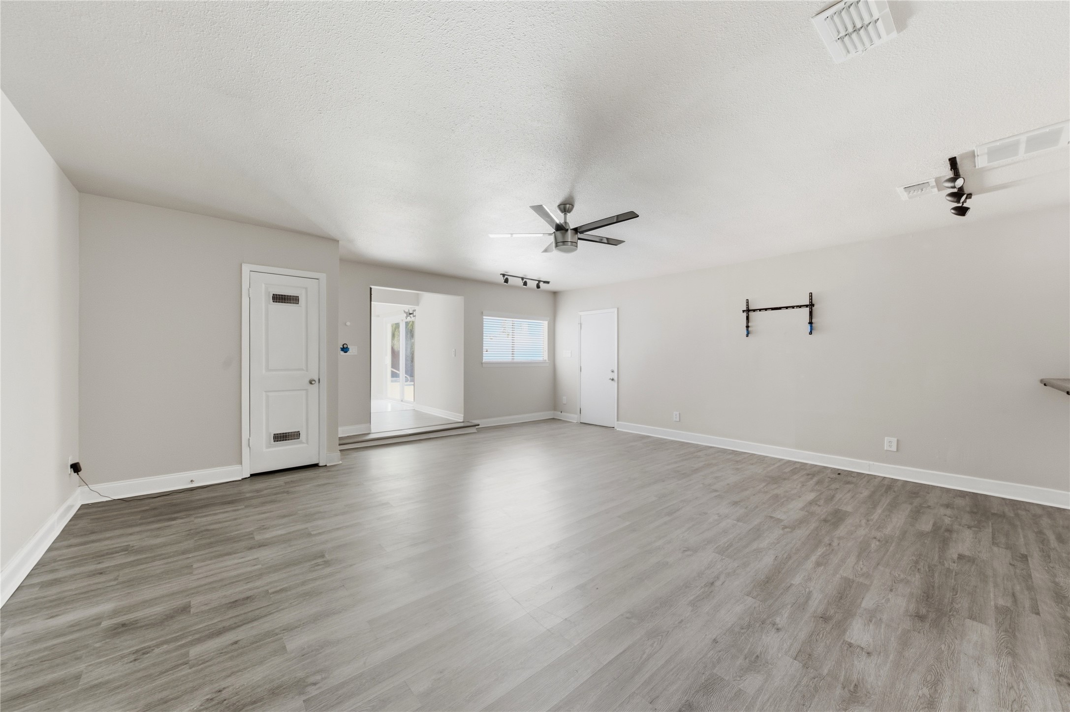 Generously sized room featuring natural light and versatile space.