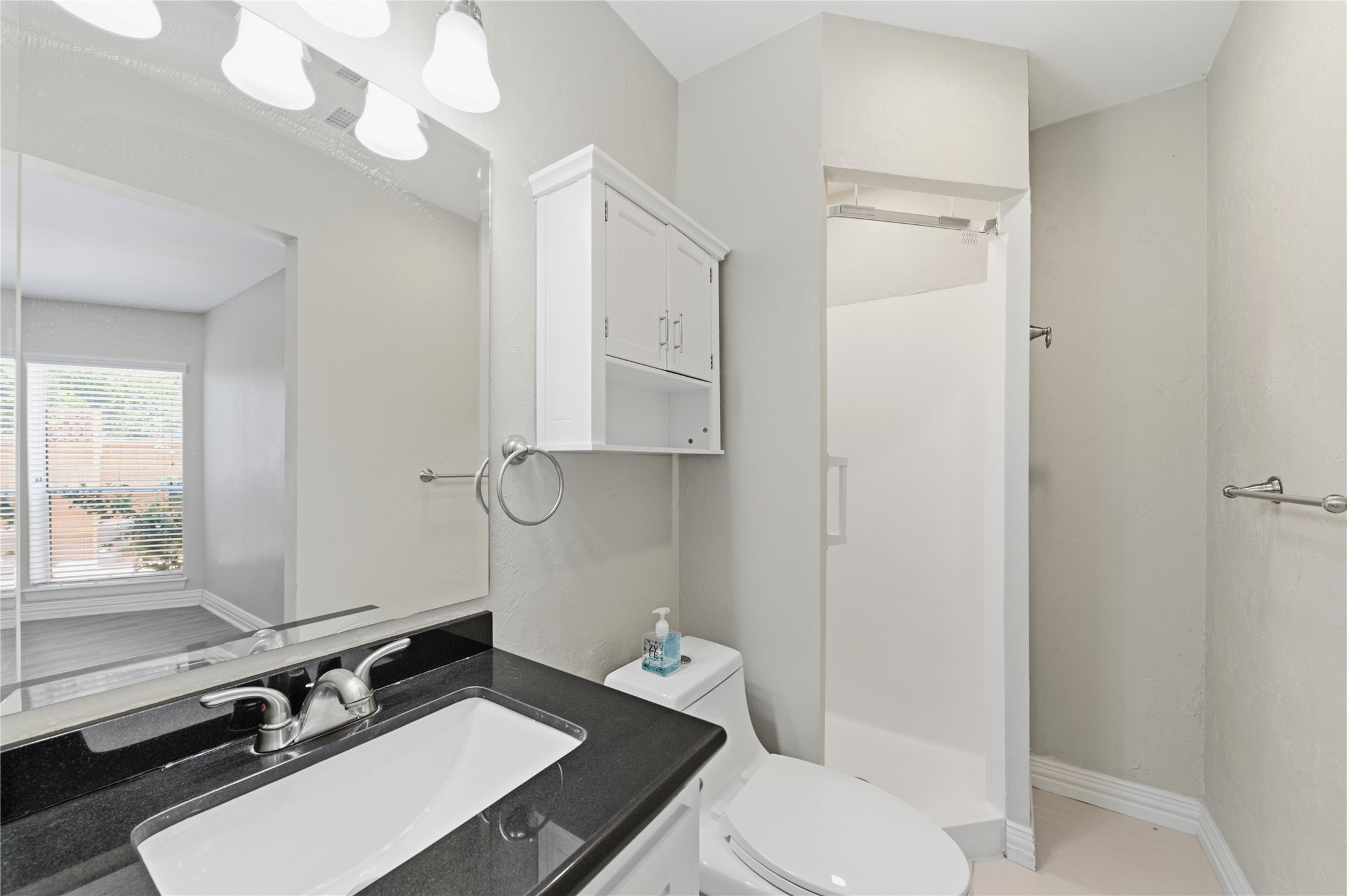 Secondary full bathroom featuring a walk-in shower.