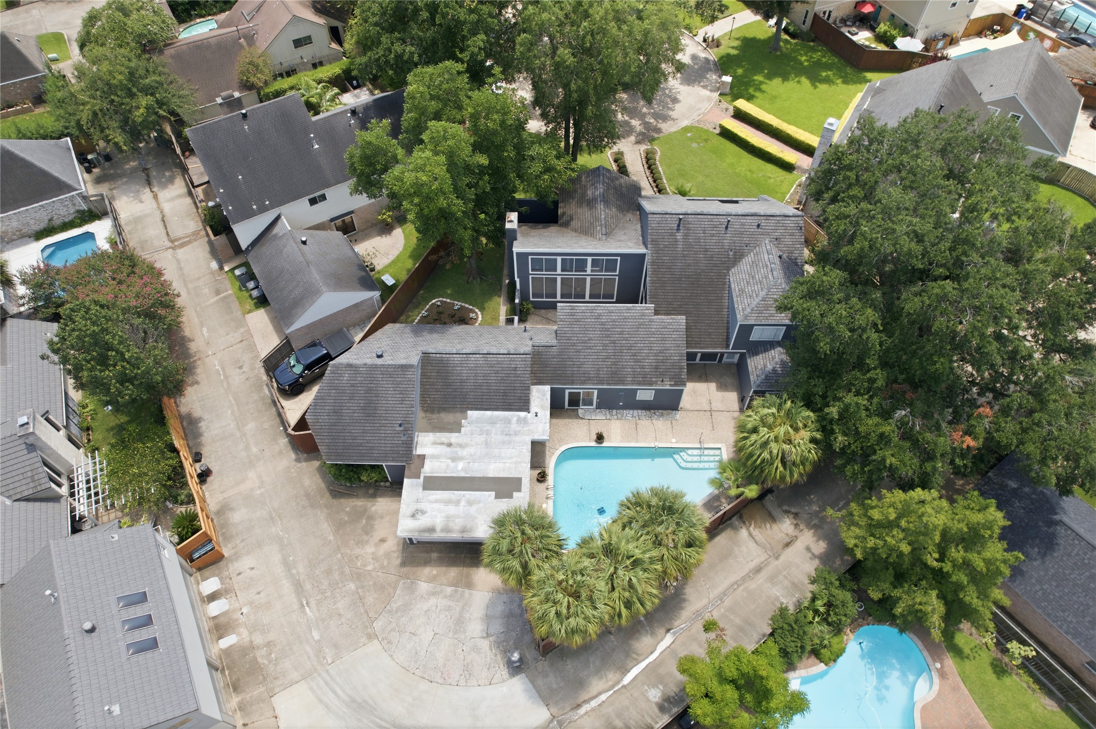 Overhead view showing the seamless layout of the home, pool, and courtyard.