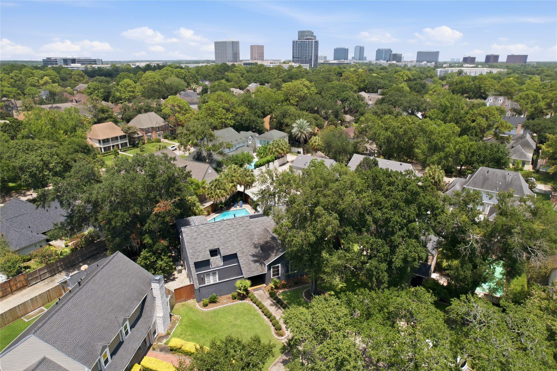 Birds-eye perspective of the property and lush surroundings.