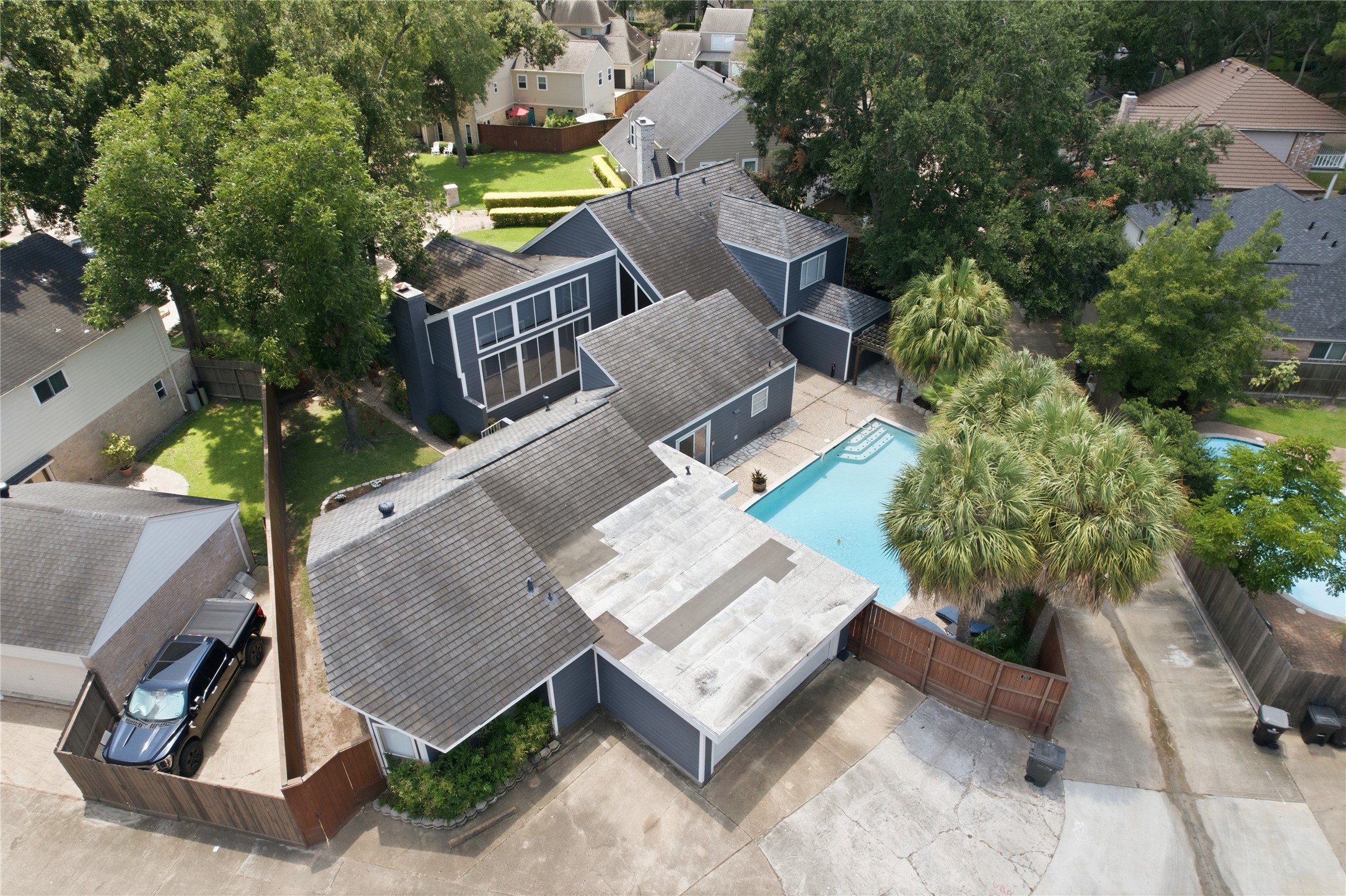 Close-up aerial view highlights the large windows and lush palm trees!
