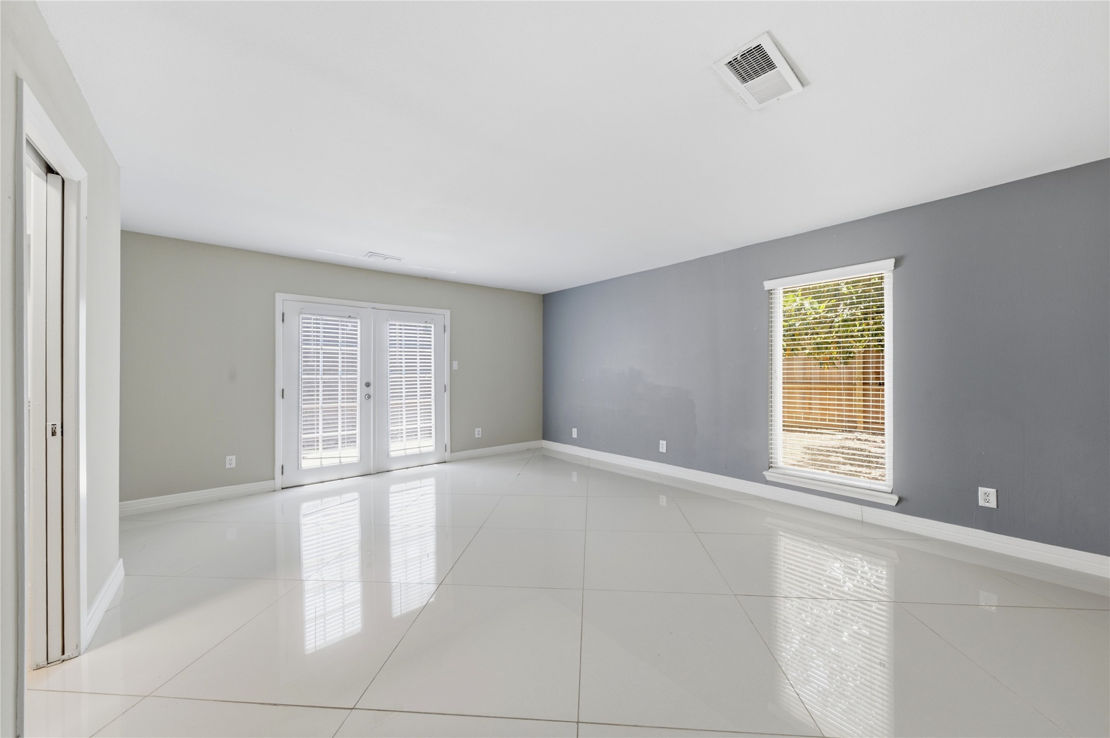 Sun-drenched primary suite with direct private access to the backyard patio.