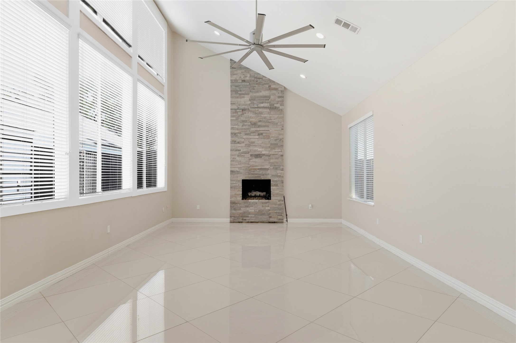 Floor-to-ceiling fireplace serves as a breathtaking focal point.