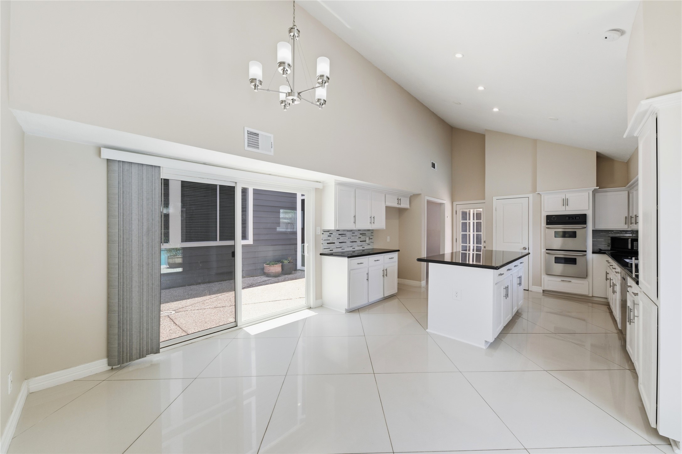Sliding glass doors off the breakfast nook seamless blend indoor and outdoor living.