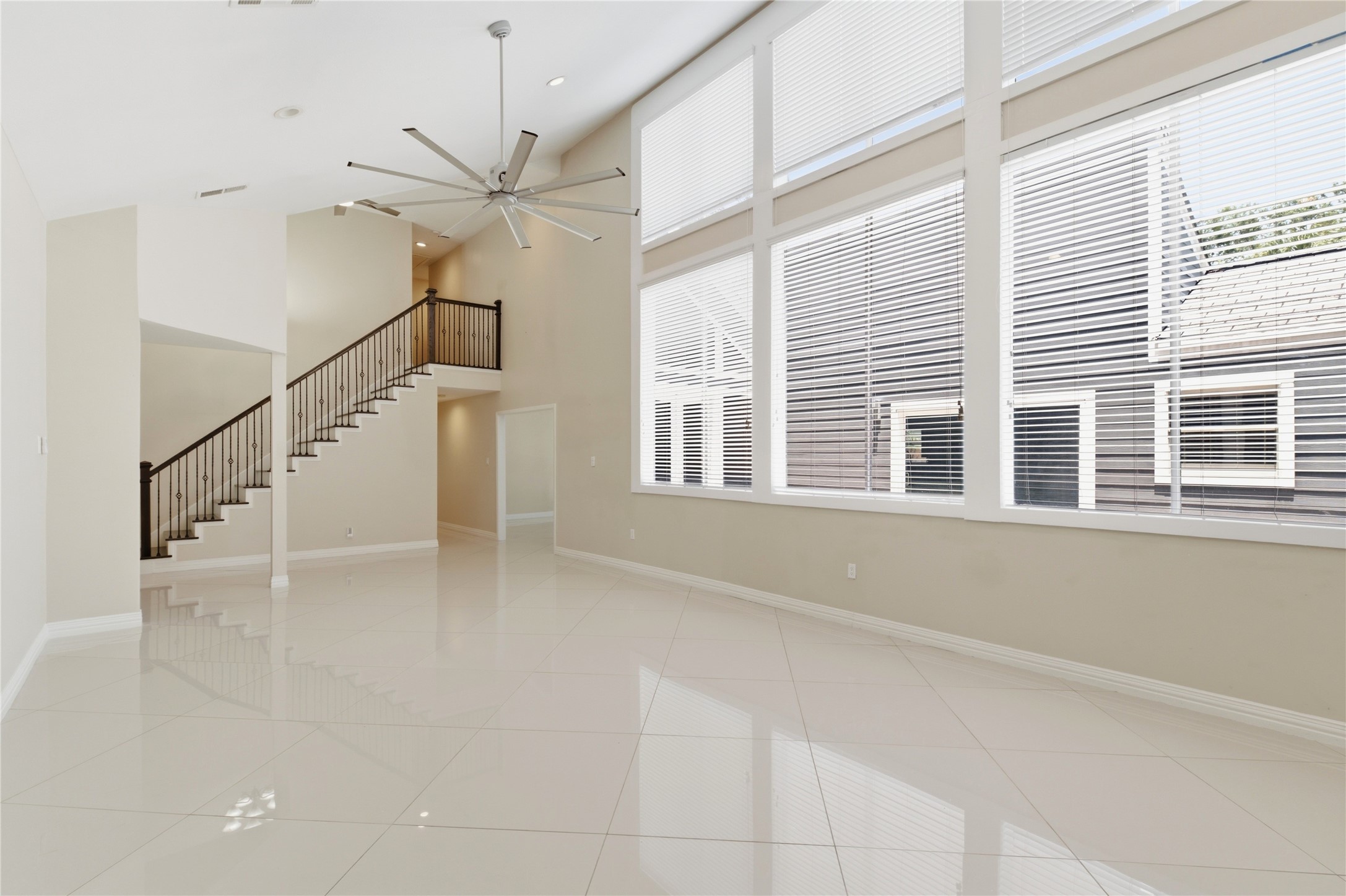Dramatic two-story living room flooded with natural light.