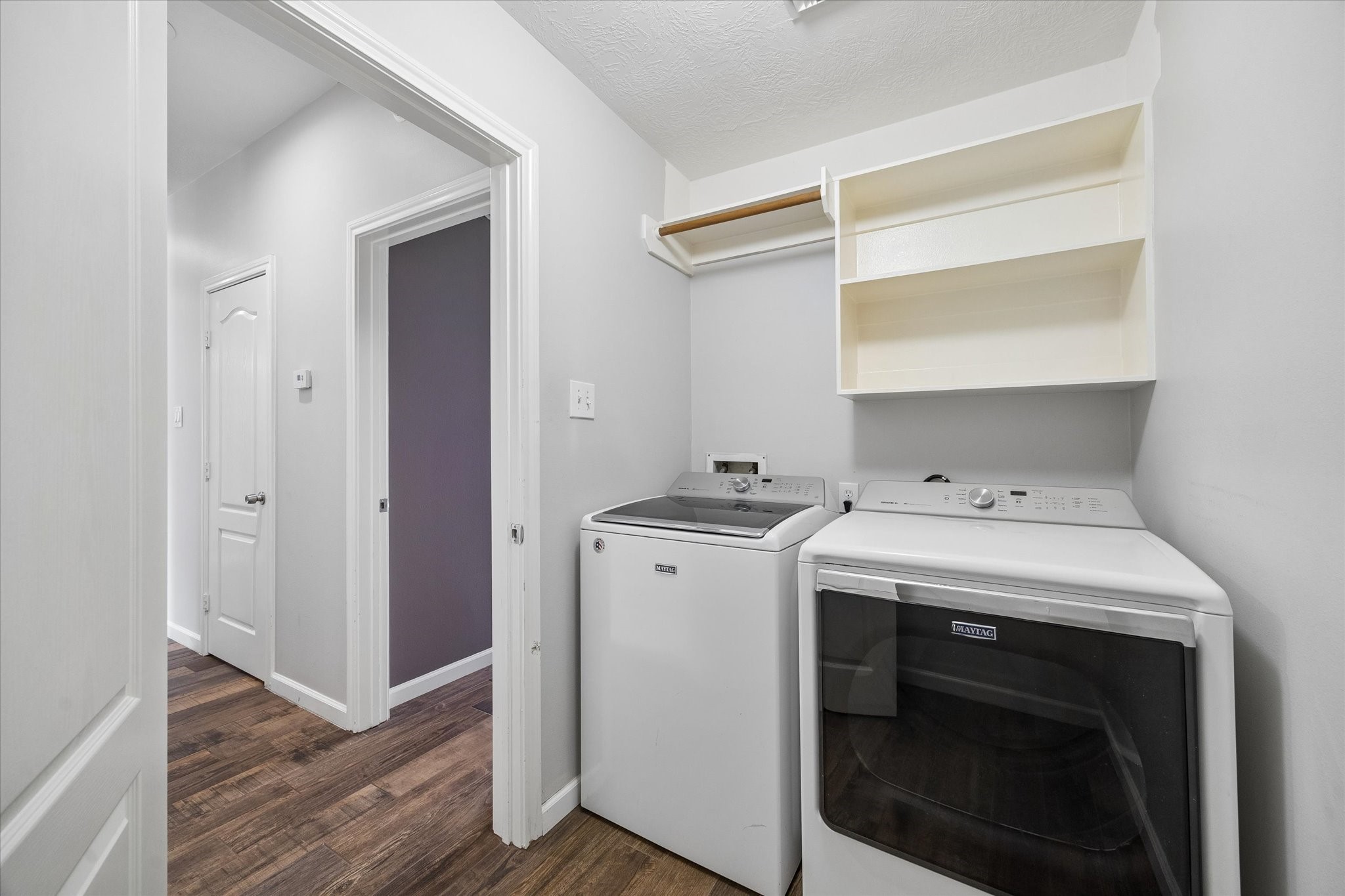 The laundry room has built-in storage and the MAYTAG washer and dryer are included with the house!