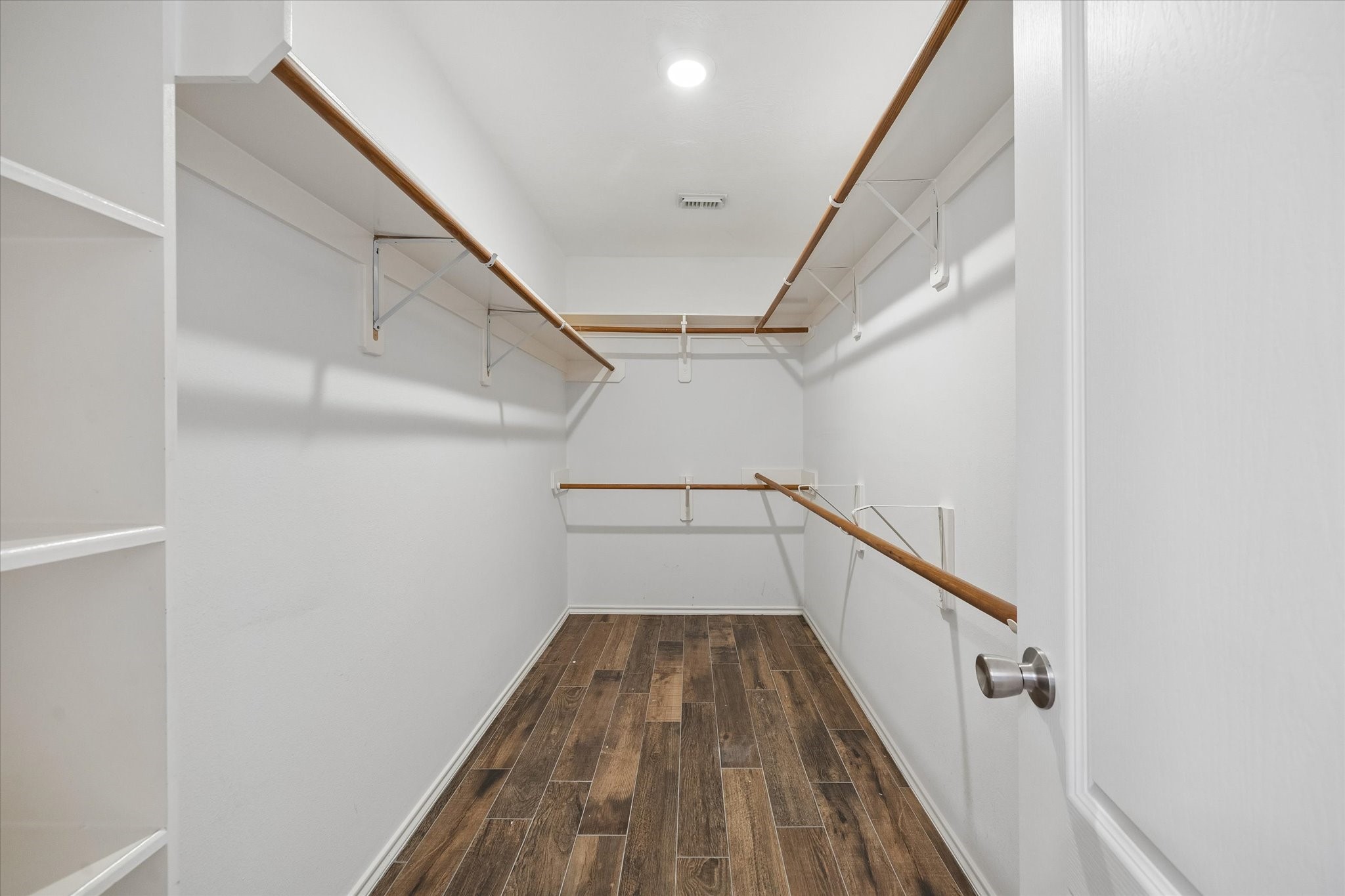 The large walk-in closet has built-in shelves making it easier to stay organized.