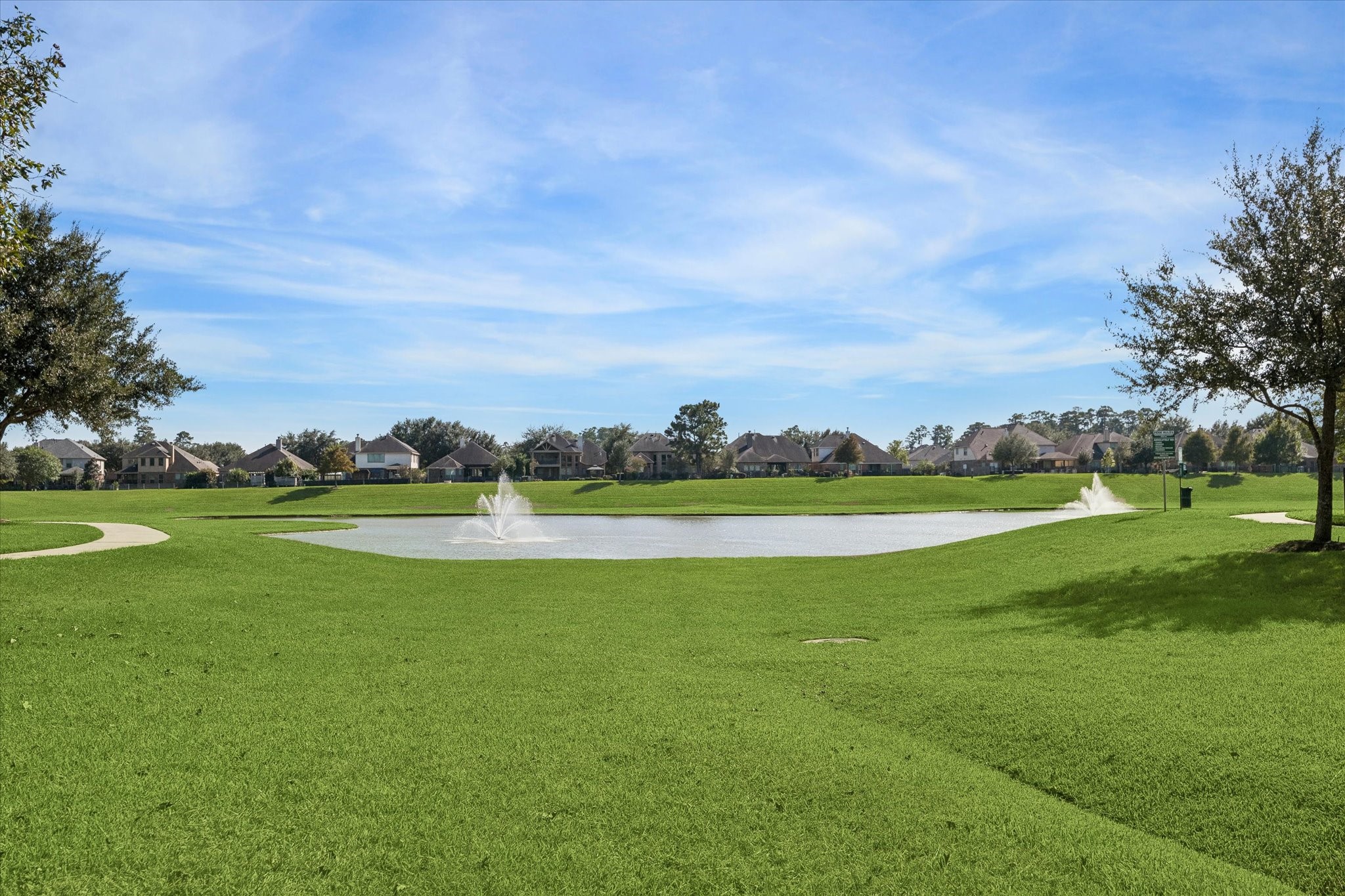 Beautiful neighborhood lake surrounded by a walking/jogging trail at the main entrance to the community.