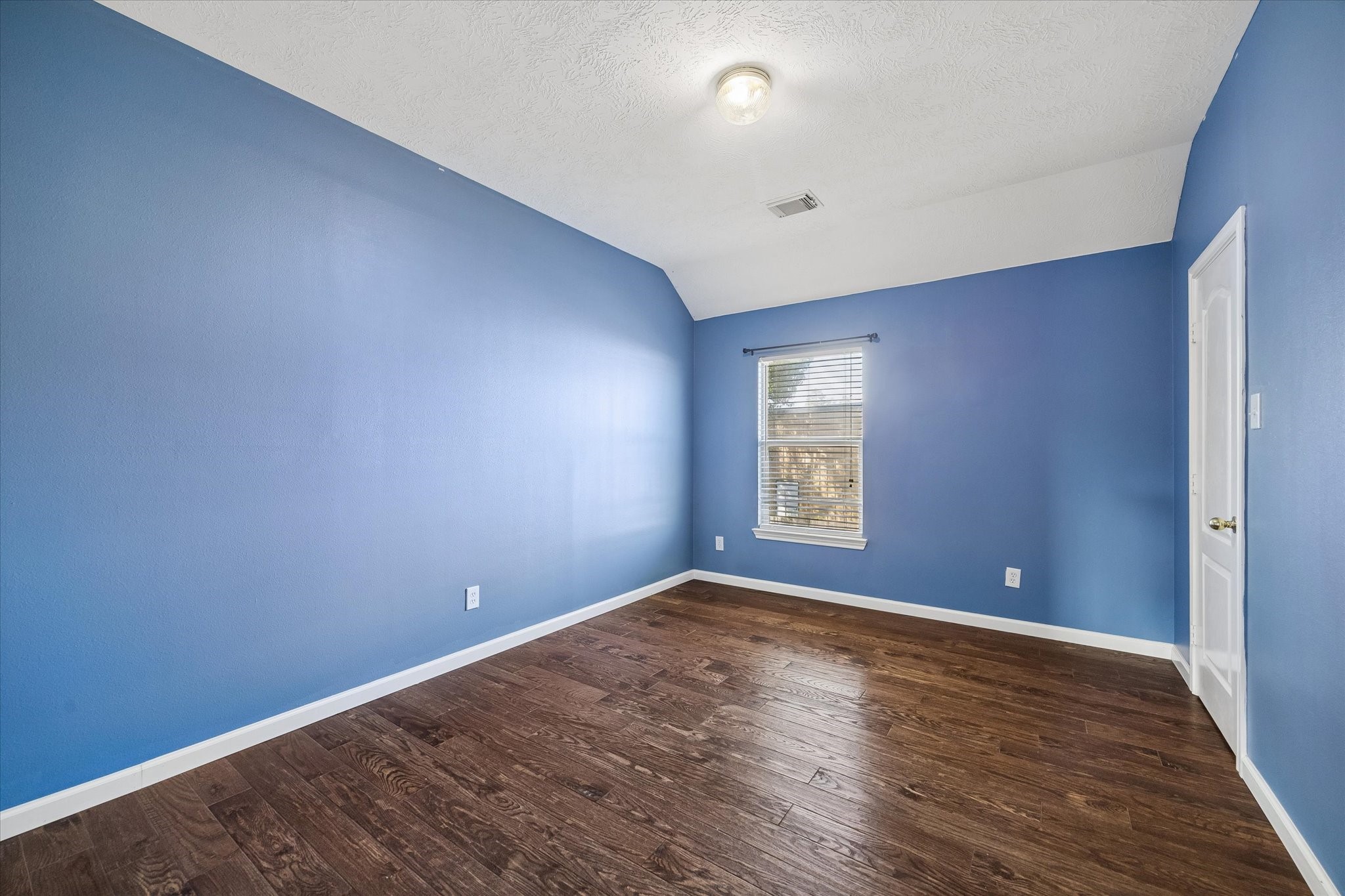 This is the first of three upstairs bedrooms.  All rooms are a good size. High ceilings and wood floors in all!