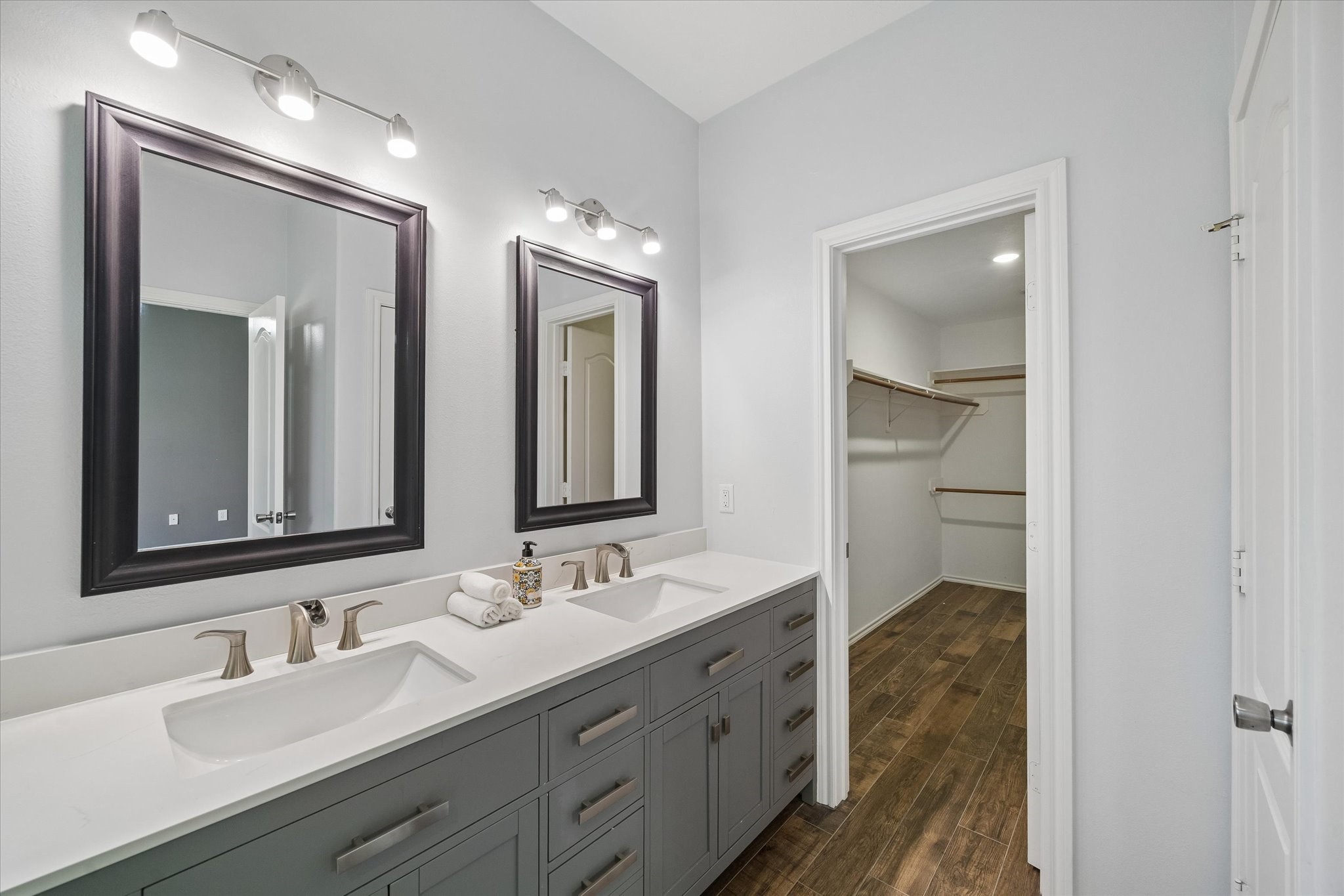 Additional updates in the bathroom inlcude double sinks, long vanity with tons of storage, waterfall faucets, framed mirrors, and lighting.