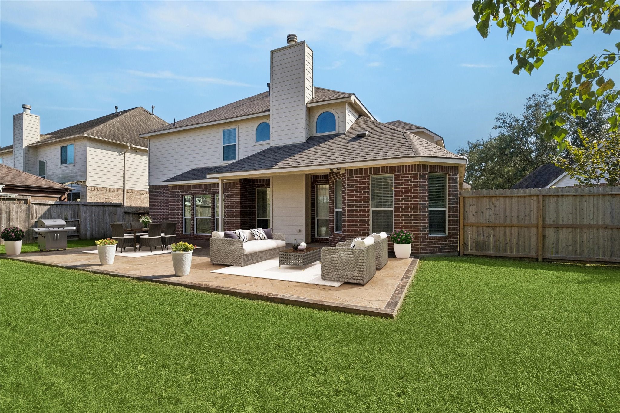 Virtually staged photo to show decorating possibilities - room for a dining set, outdoor living furniture, grill, and a fire pit!