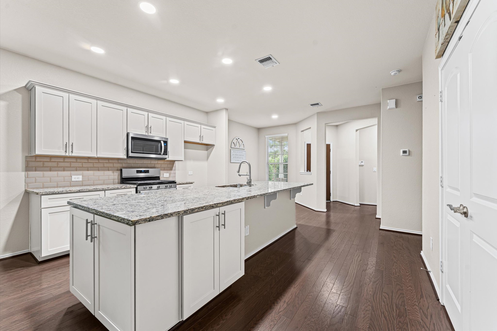 The stunning kitchen offers seamless storage and a sophisticated, organizing aesthetics.