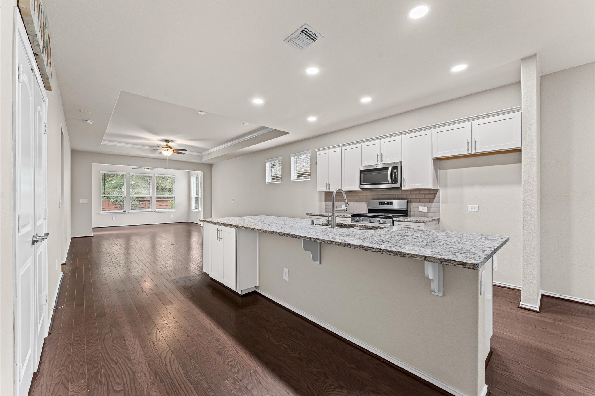 Flooded with a wealth of natural light, the space is defined by an expansive central prep island with generous counter space and dedicated breakfast bar seating. This creates the ultimate casual gathering spot for family and friends to linger while meals are being prepared. Flooded with a wealth of natural light, the space is defined by an expansive central prep island with generous counter space and dedicated breakfast bar seating. This creates the ultimate casual gathering spot for family and friends to linger while meals are being prepared.