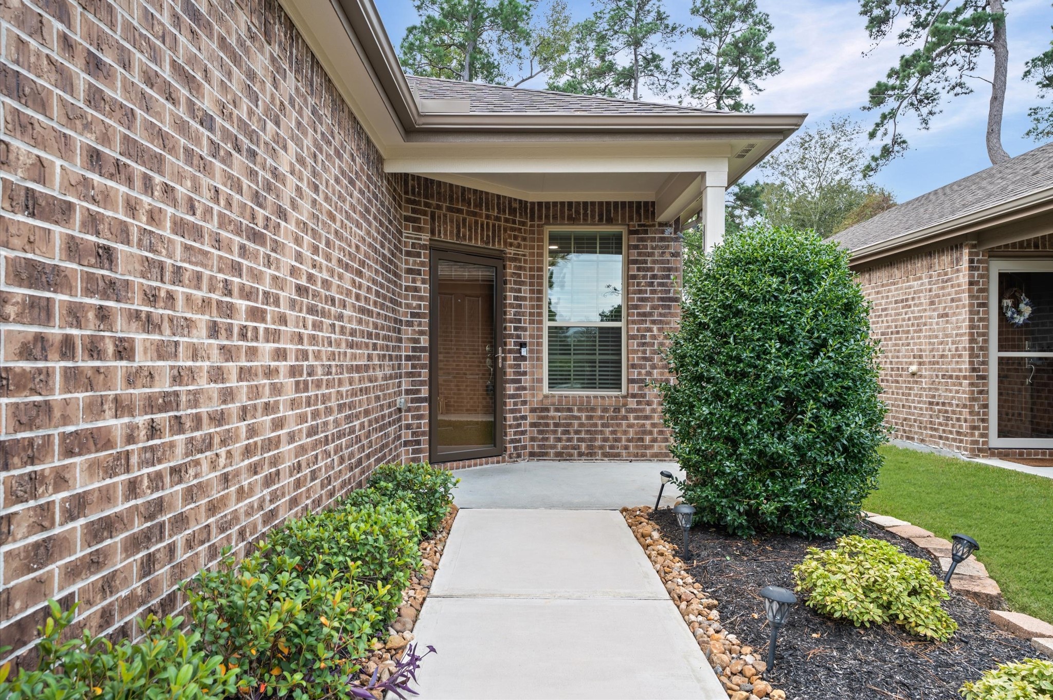A stunning front porch with a glass security door establishes an immediate tone of sophisticated curb appeal while providing an inviting, secure transition into this beautiful home. A stunning front porch with a glass security door establishes an immediate tone of sophisticated curb appeal while providing an inviting, secure transition into this beautiful home.