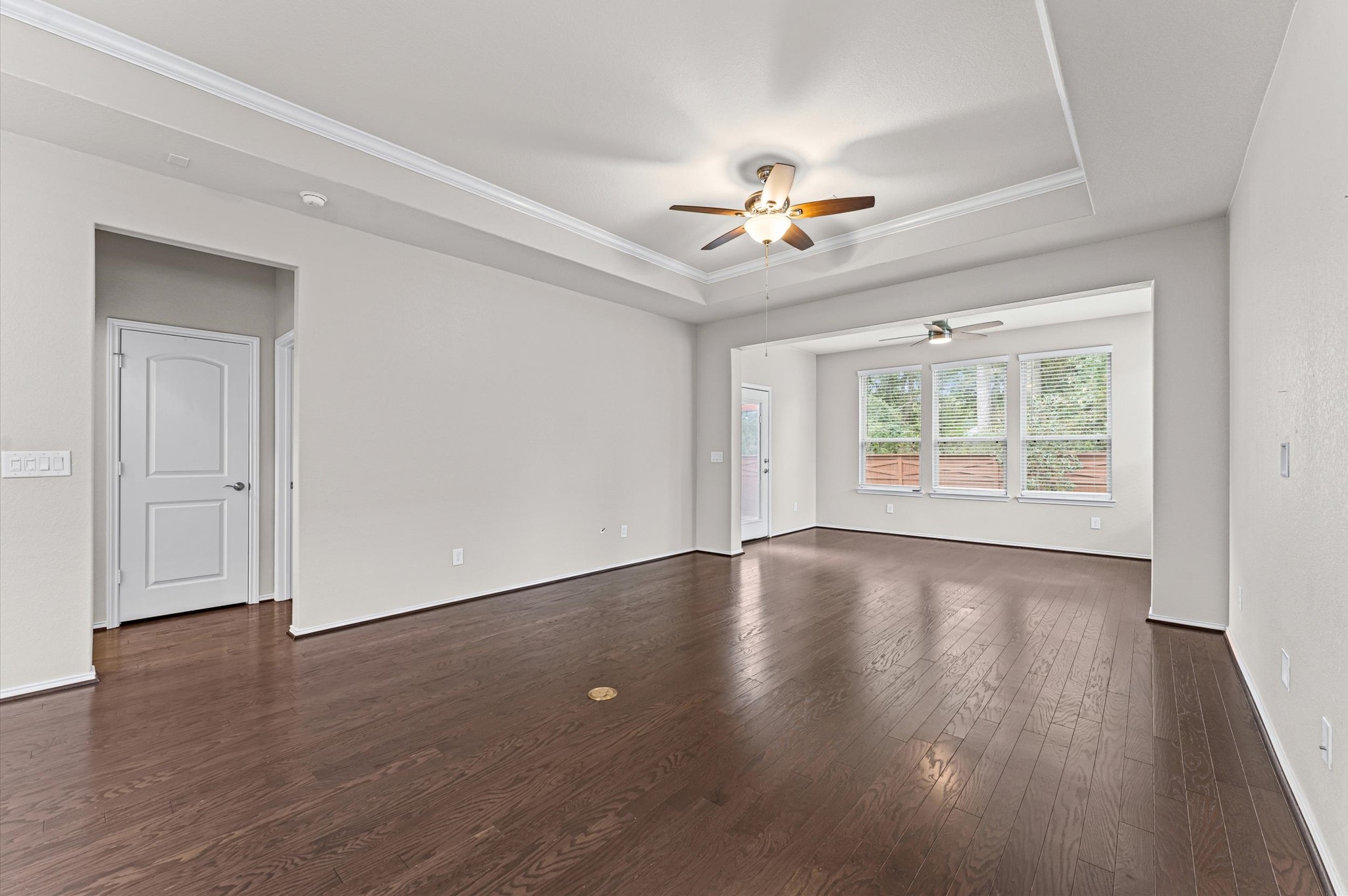 Blessed with a continuous wash of bright, daytime sunshine, the living room's open-concept design flows unimpeded into the adjacent kitchen and sunroom, ensuring you never miss a moment of conversation with guests.