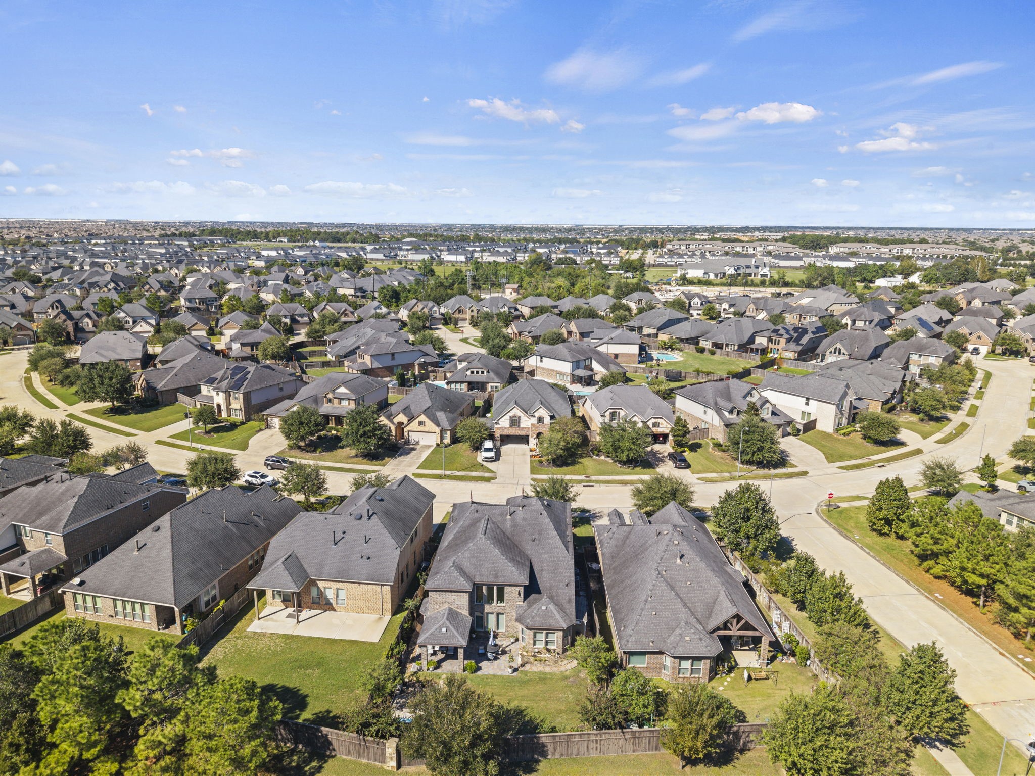 Nestled in a sprawling suburban neighborhood, this home sits on a tree-lined street with well-maintained yards and modern architecture, offering a serene and family-friendly environment.