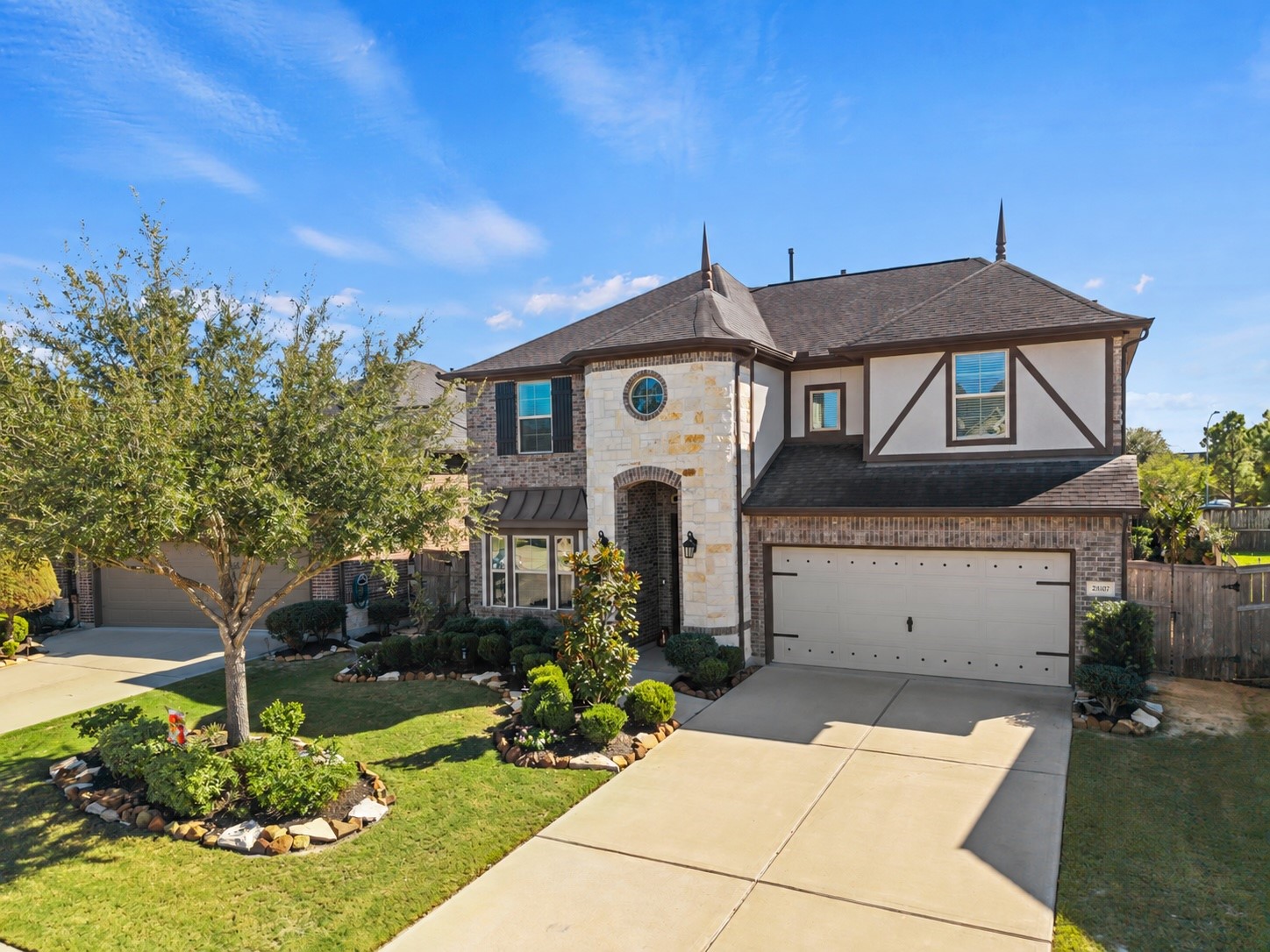 Stunning two-story home with elegant stone and brick facade, beautifully landscaped front yard, and a spacious two-car garage. Stunning two-story home with elegant stone and brick facade, beautifully landscaped front yard, and a spacious two-car garage.
