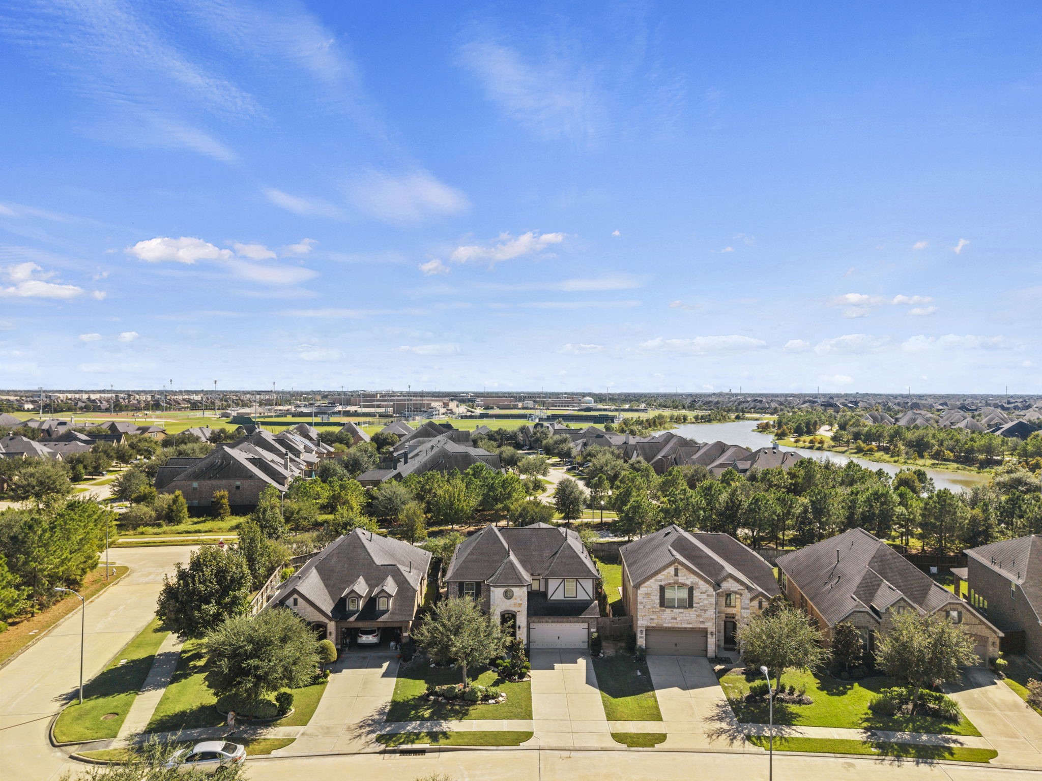 Nestled in a serene neighborhood, this charming home offers a picturesque view of lush greenery and tranquil water features, perfect for peaceful living.