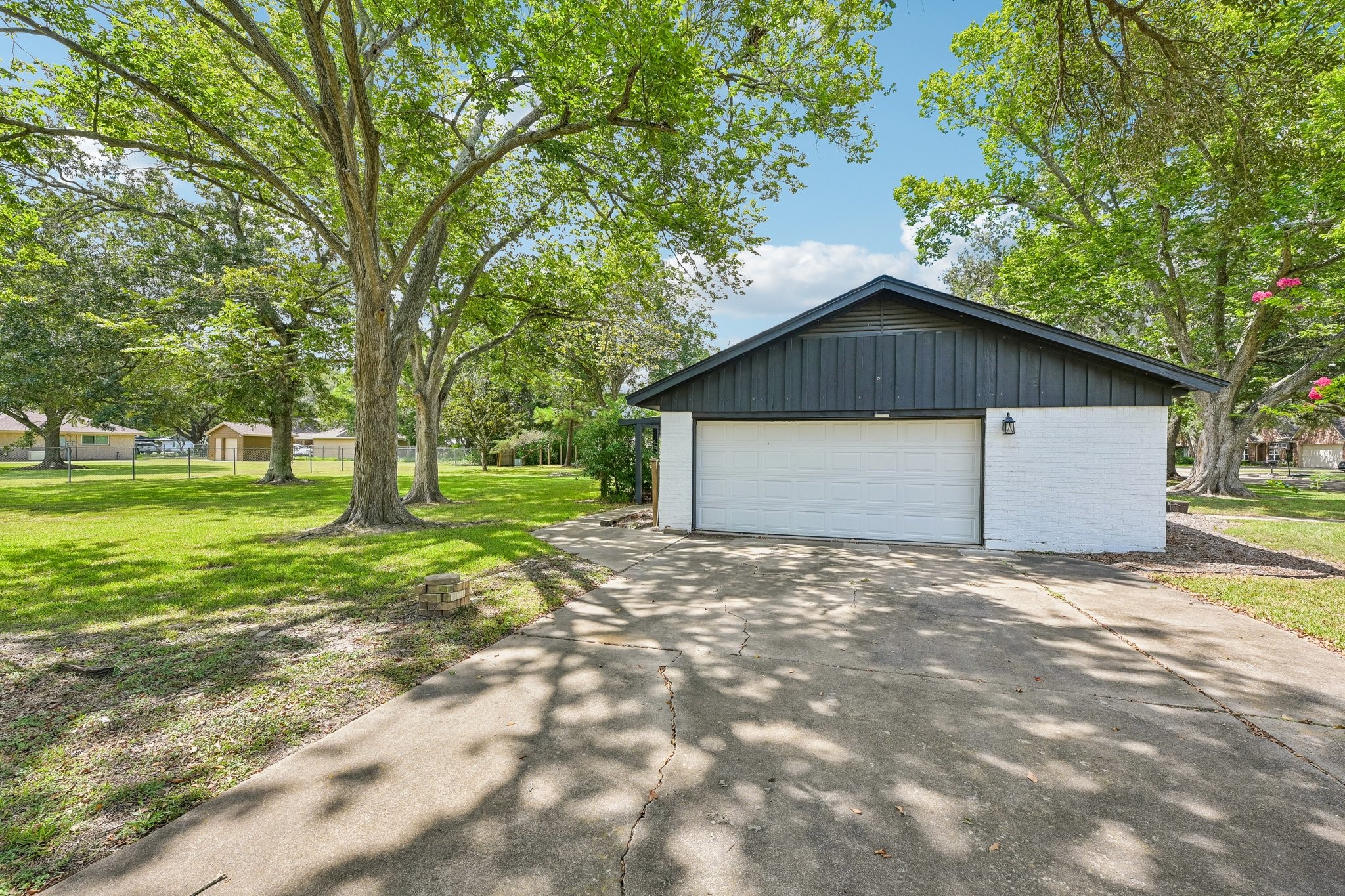 Double wide driveway, 2 car garage, and extra garage space for a workshop area.