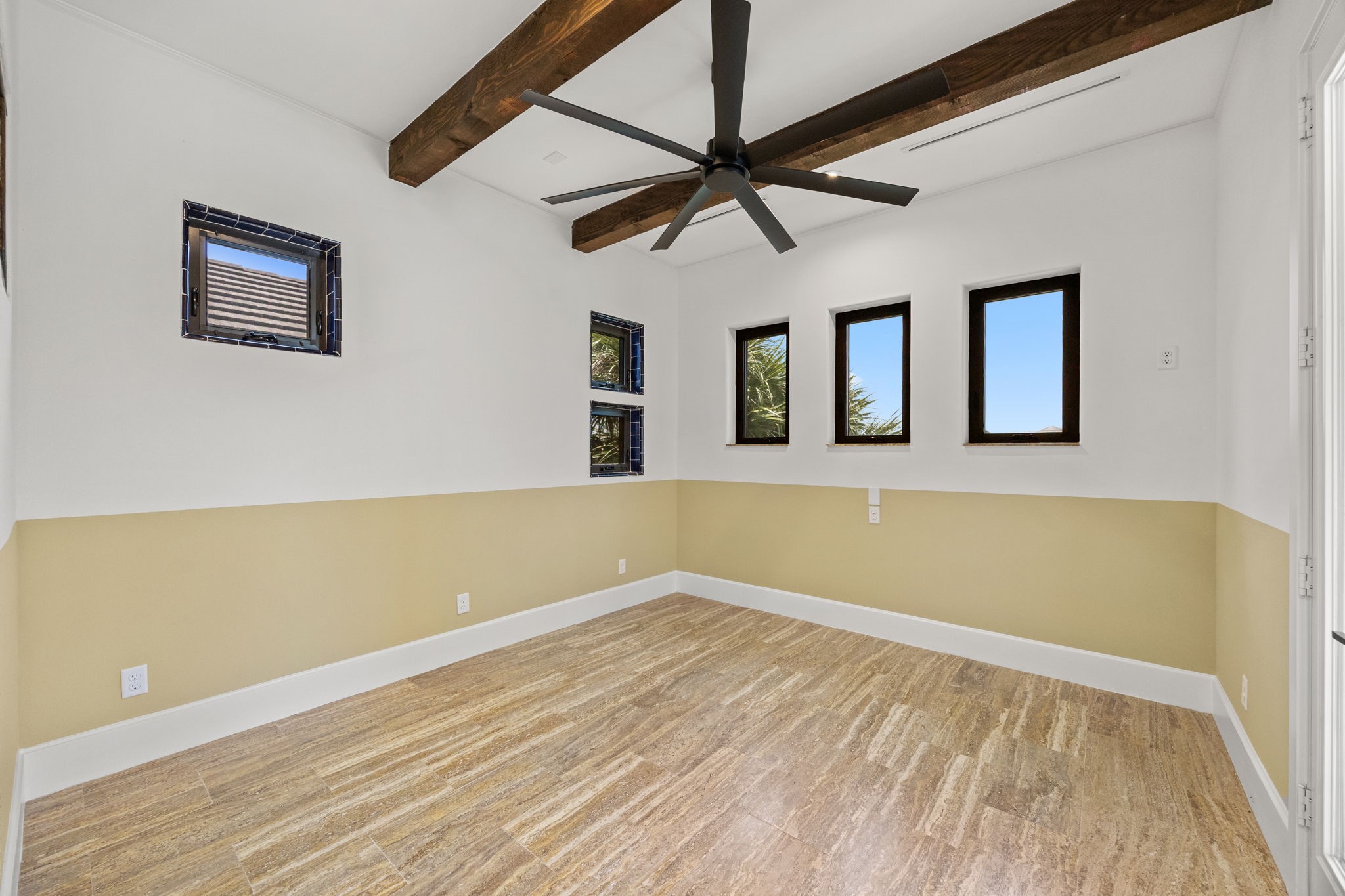 A versatile flex room connects the primary bedroom and bath and includes direct access to the balcony, enhancing the suites private retreat feel.