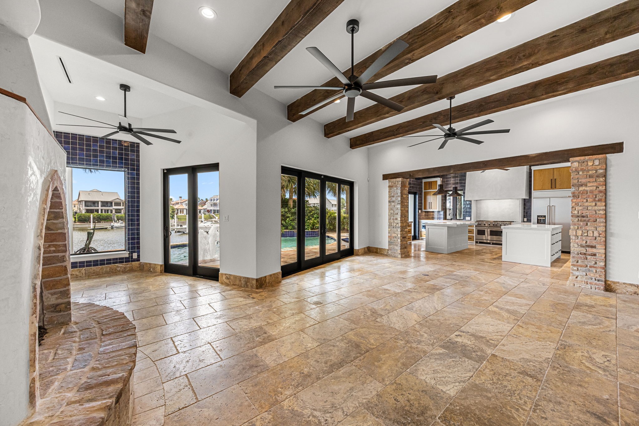 From the living room, the chef's kitchen takes center stage with its impressive double islands, custom finishes, and thoughtfully designed gathering spaces.