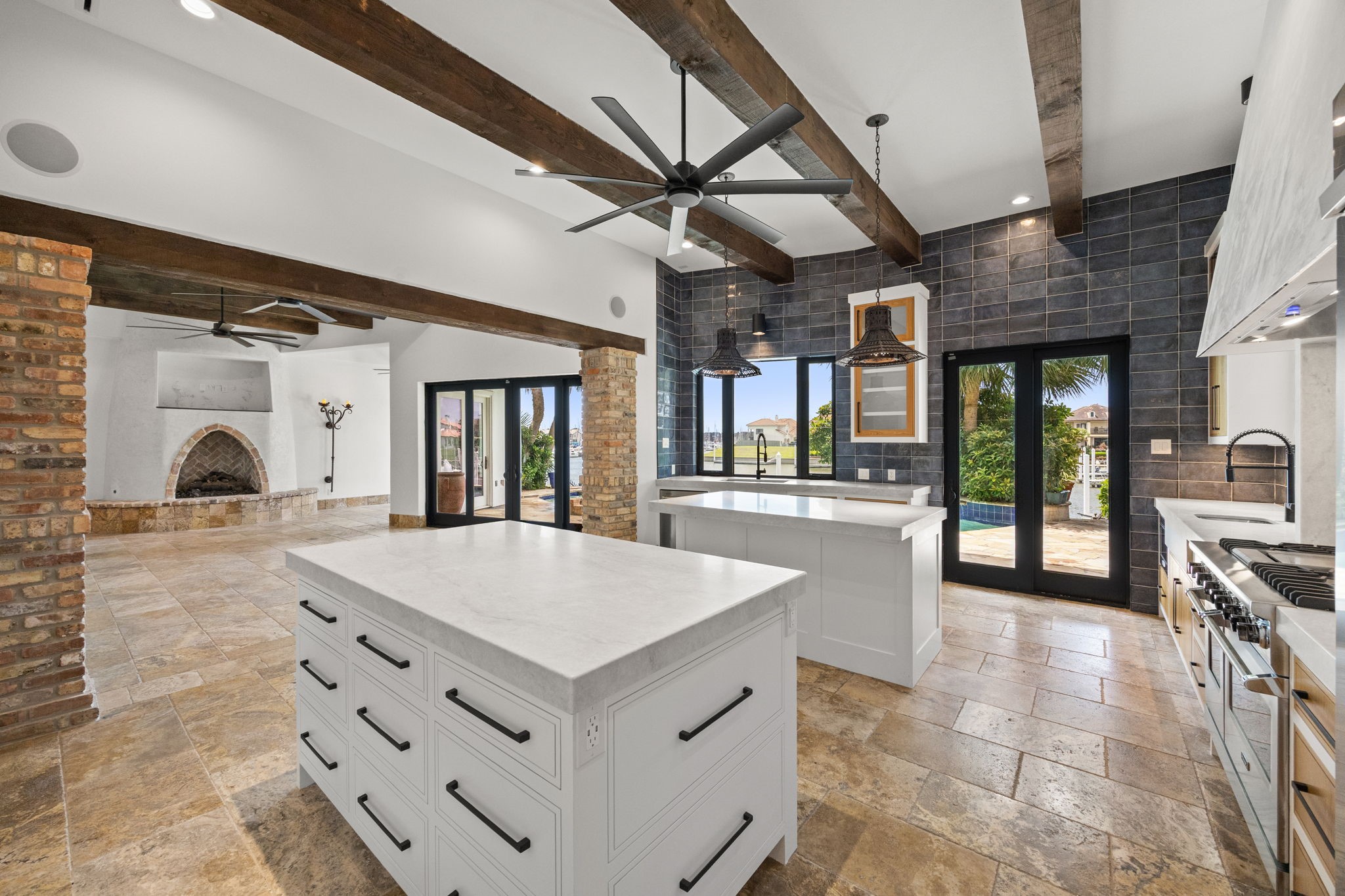 The dual kitchen islands are thoughtfully designed with soft-close drawers throughout, including oversized pot and pan drawers that provide exceptional organization and convenience.