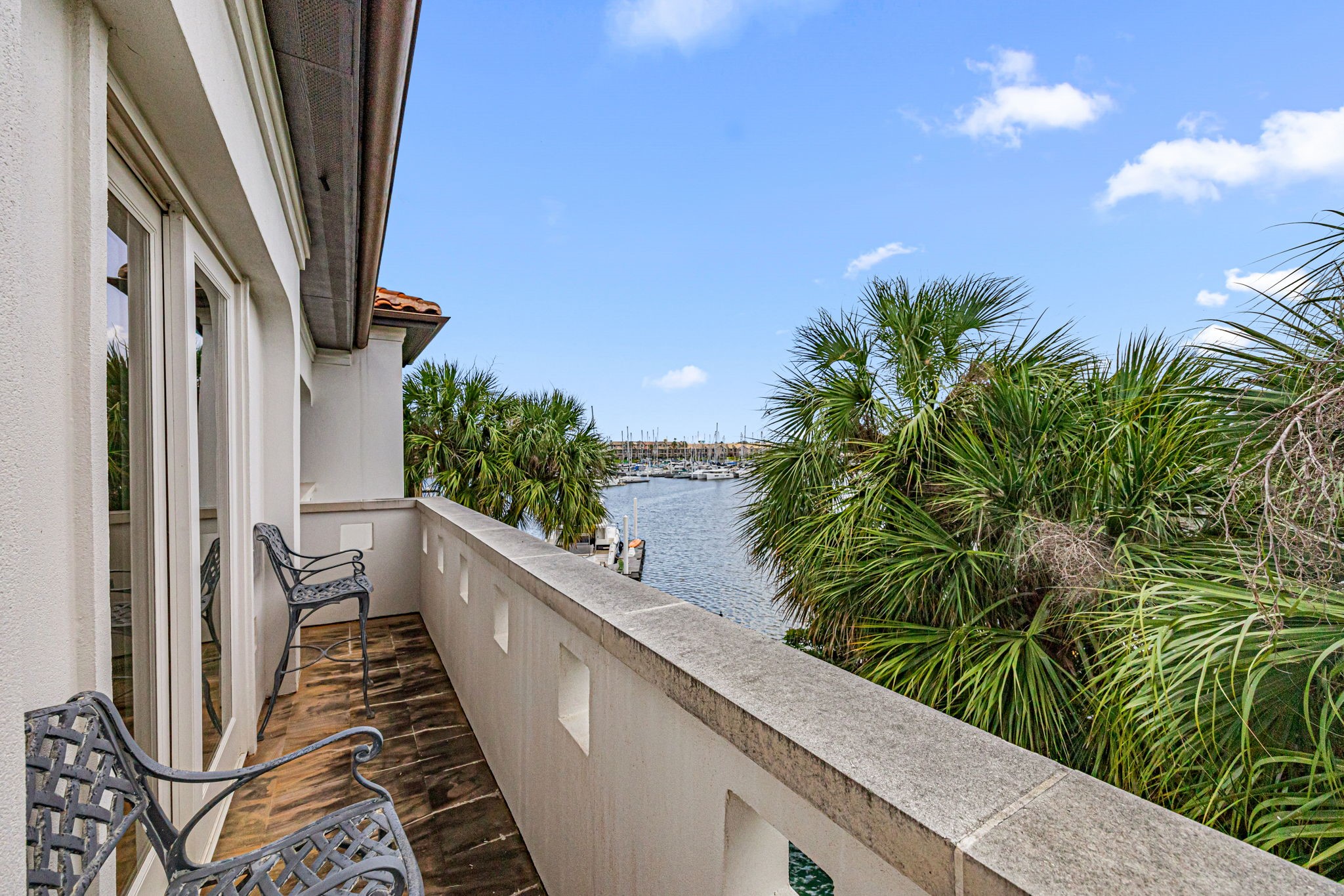 A private second-floor balcony extends from the primary bedroom, offering a peaceful outdoor retreat with elevated views.