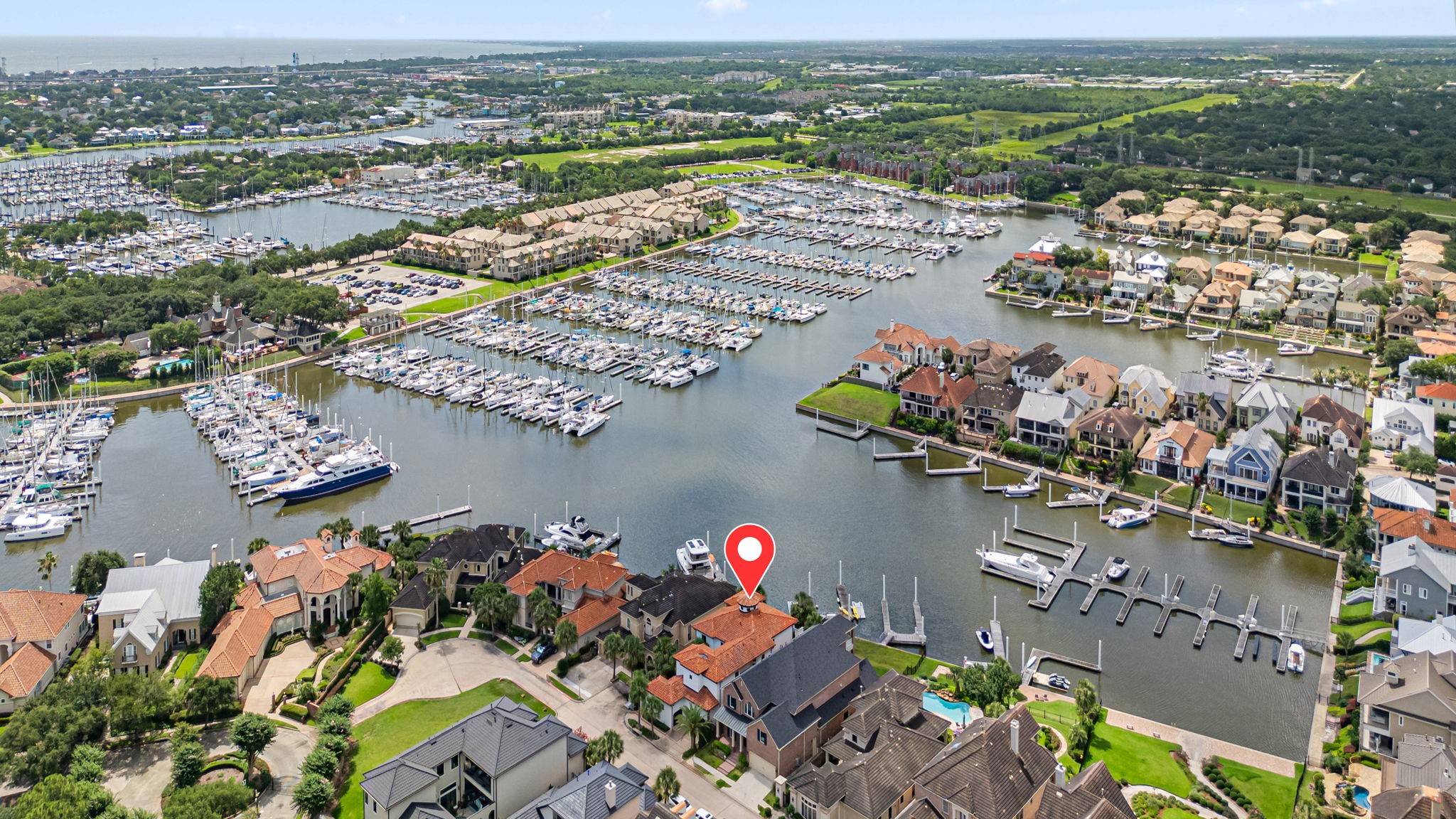 Aerial view of the home and private marina showcasing its premier waterfront setting and exceptional location.