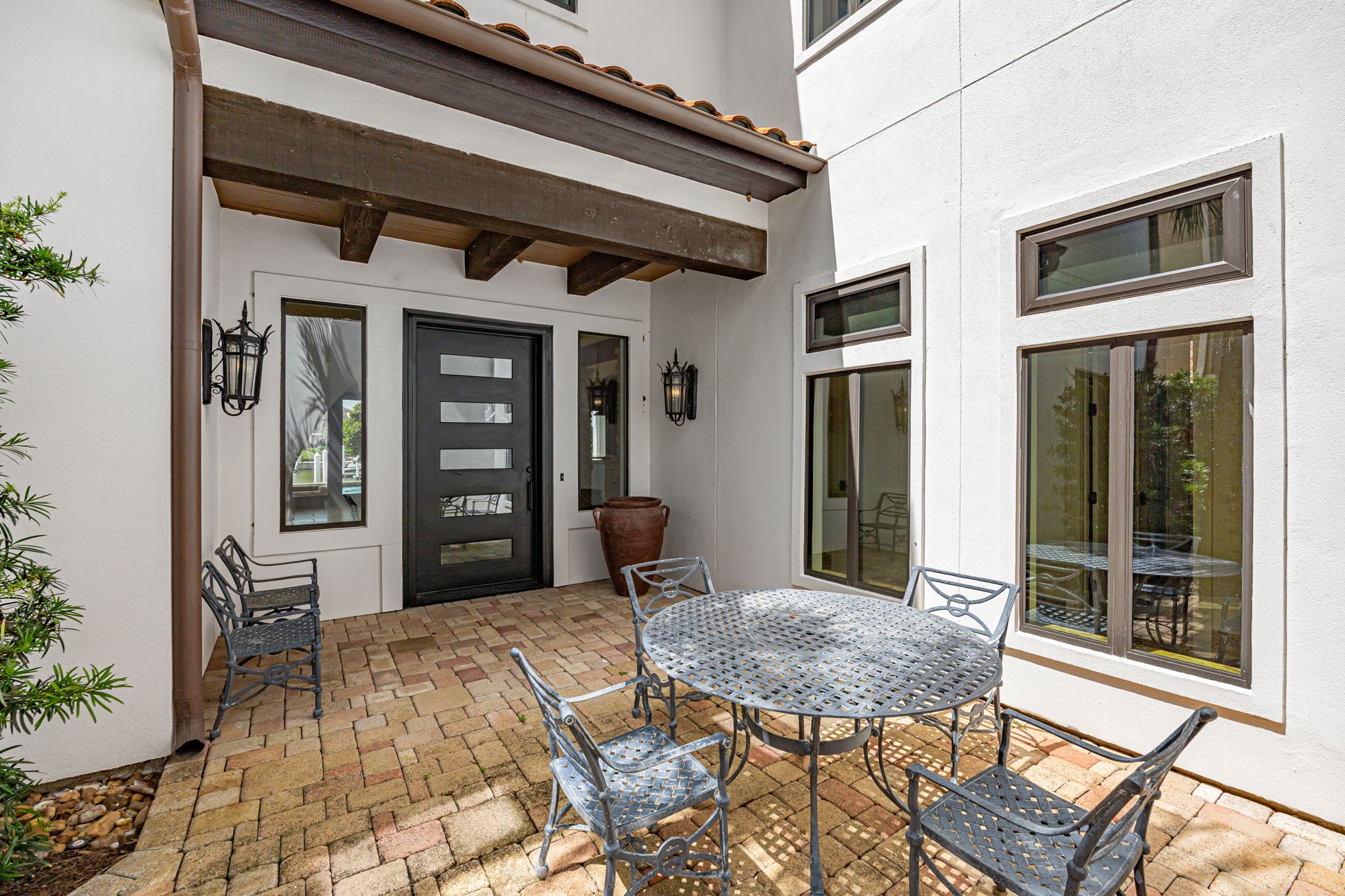 A secure steel entry door opens to a welcoming patio space at the entrance, blending durability with outdoor charm. A secure steel entry door opens to a welcoming patio space at the entrance, blending durability with outdoor charm.