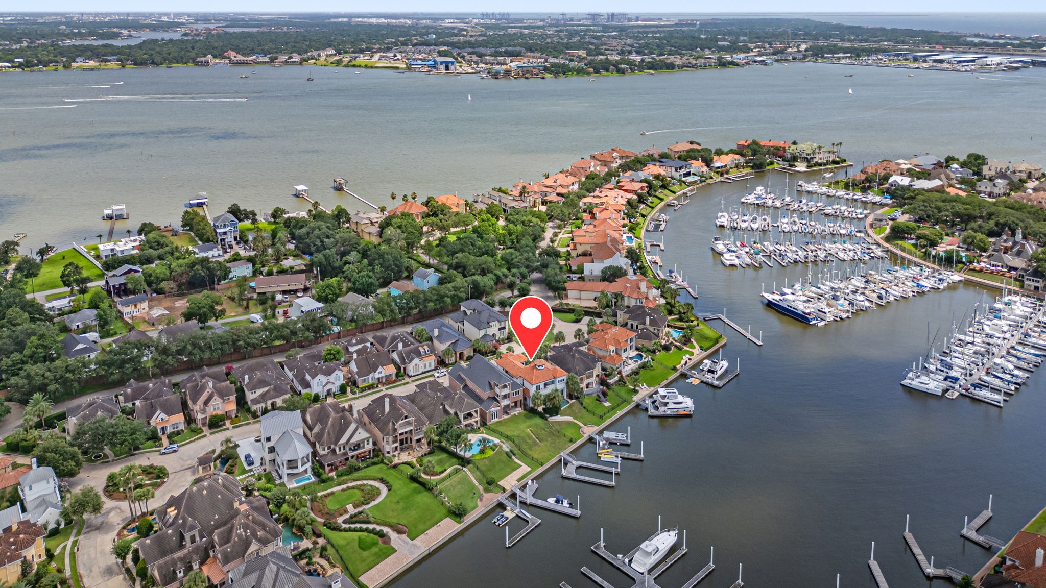 From above, the home and marina are beautifully framed by the surrounding waterways, including a narrow deep-water exit that offers controlled access and added protection from the bay.