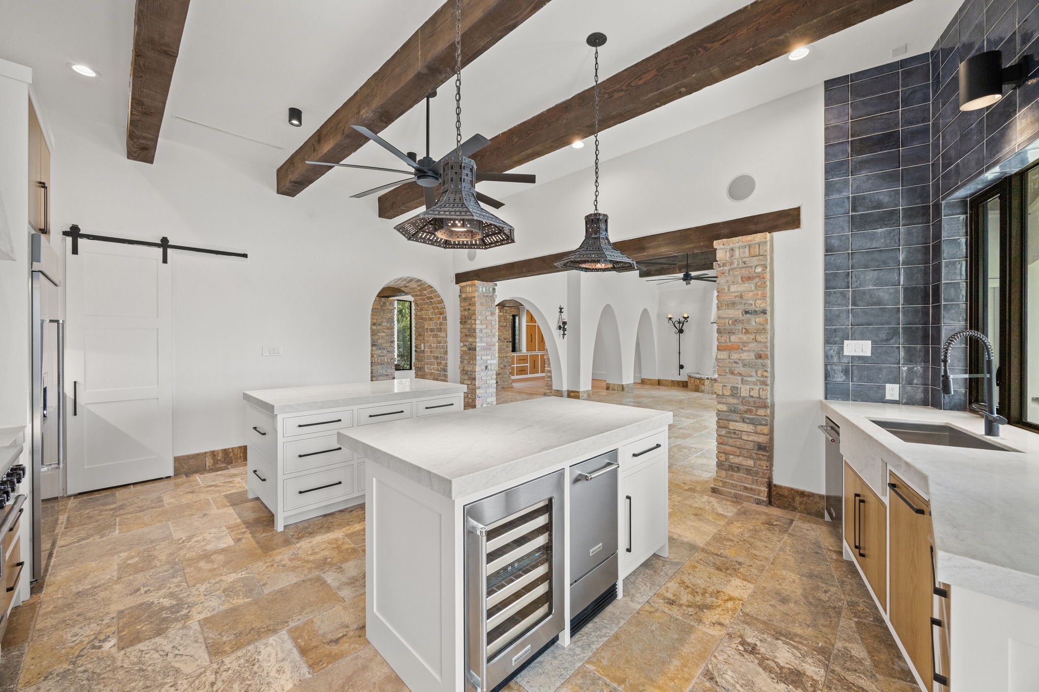 The kitchen is further enhanced by a separate ice maker and beverage cooler, adding convenience and functionality for effortless entertaining.