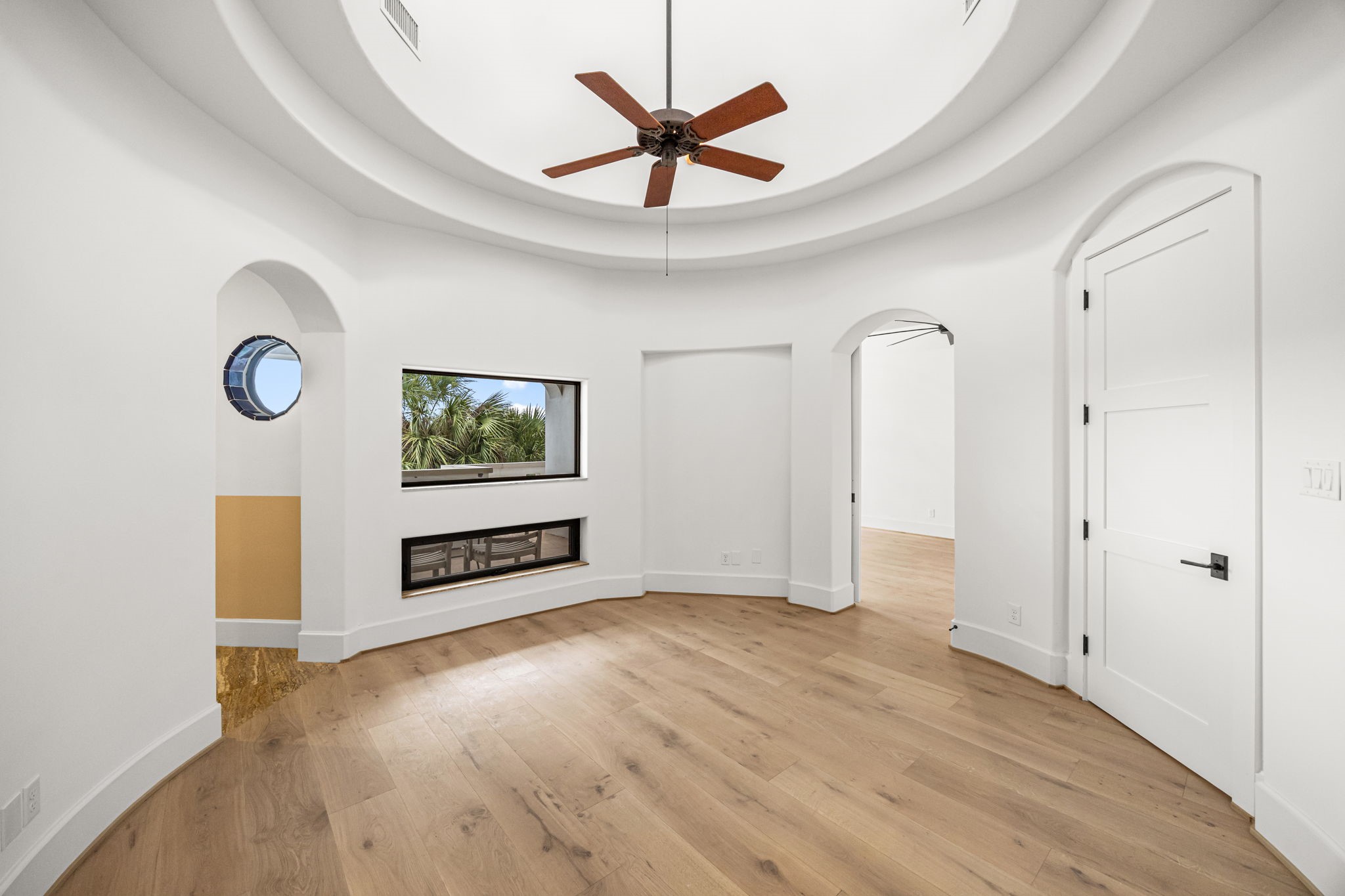 A grand entry leads to the upstairs primary suite, introducing a thoughtful layout of interconnected spaces that could easily serve as a private study. The bedroom and bath are positioned on opposite sides for enhanced privacy.