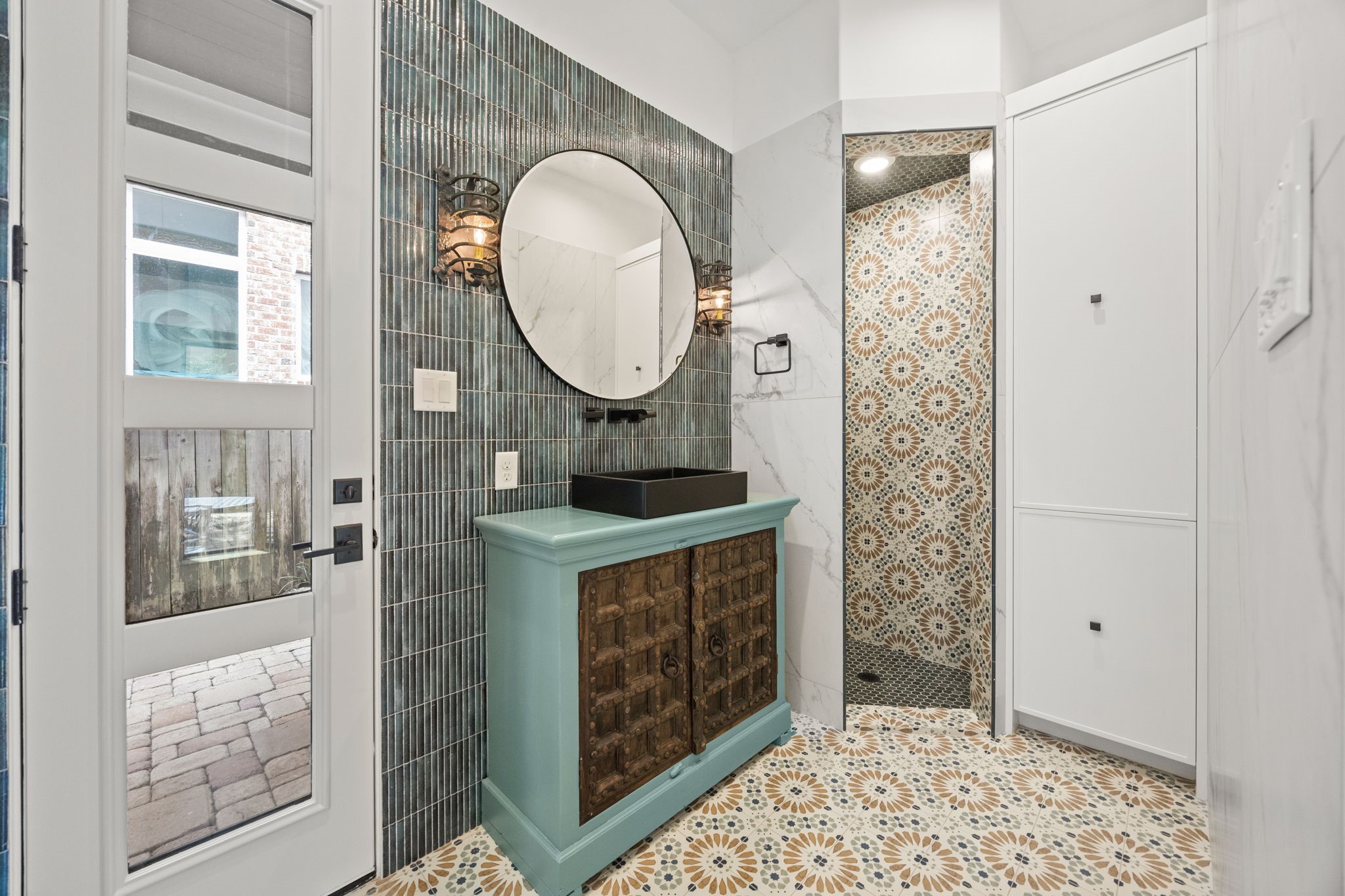 The full cabana bath is beautifully accented throughout and includes an exterior door with direct access to the pool, enhancing convenience for resort-style living.