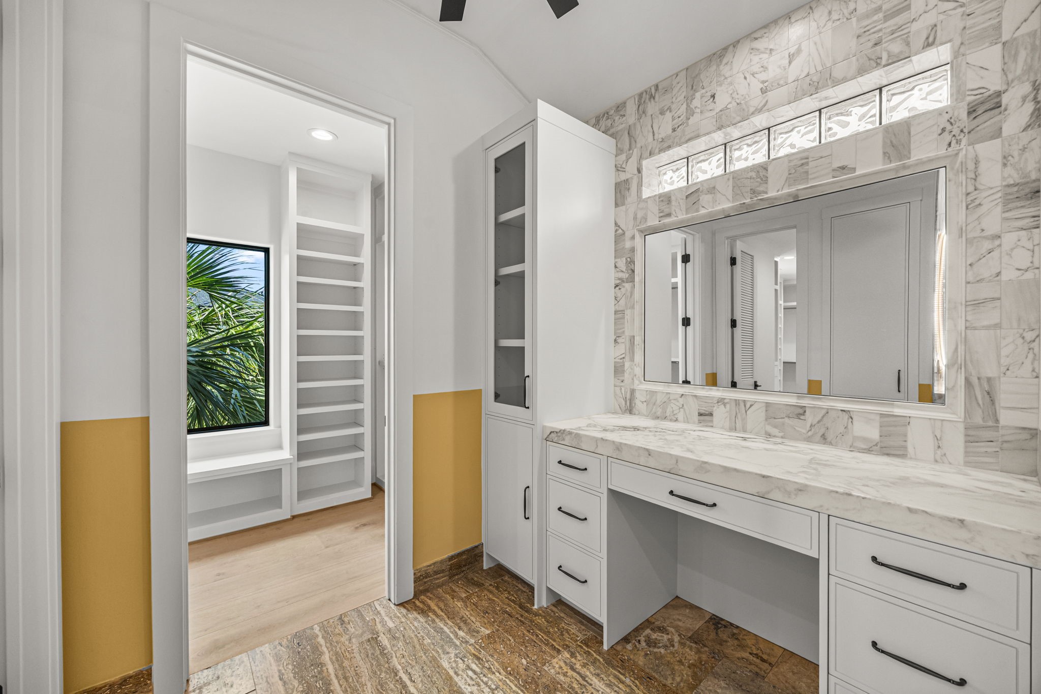 The upstairs primary bath vanity offers a thoughtfully designed layout with views into the second walk-in closet, enhancing convenience and flow.
